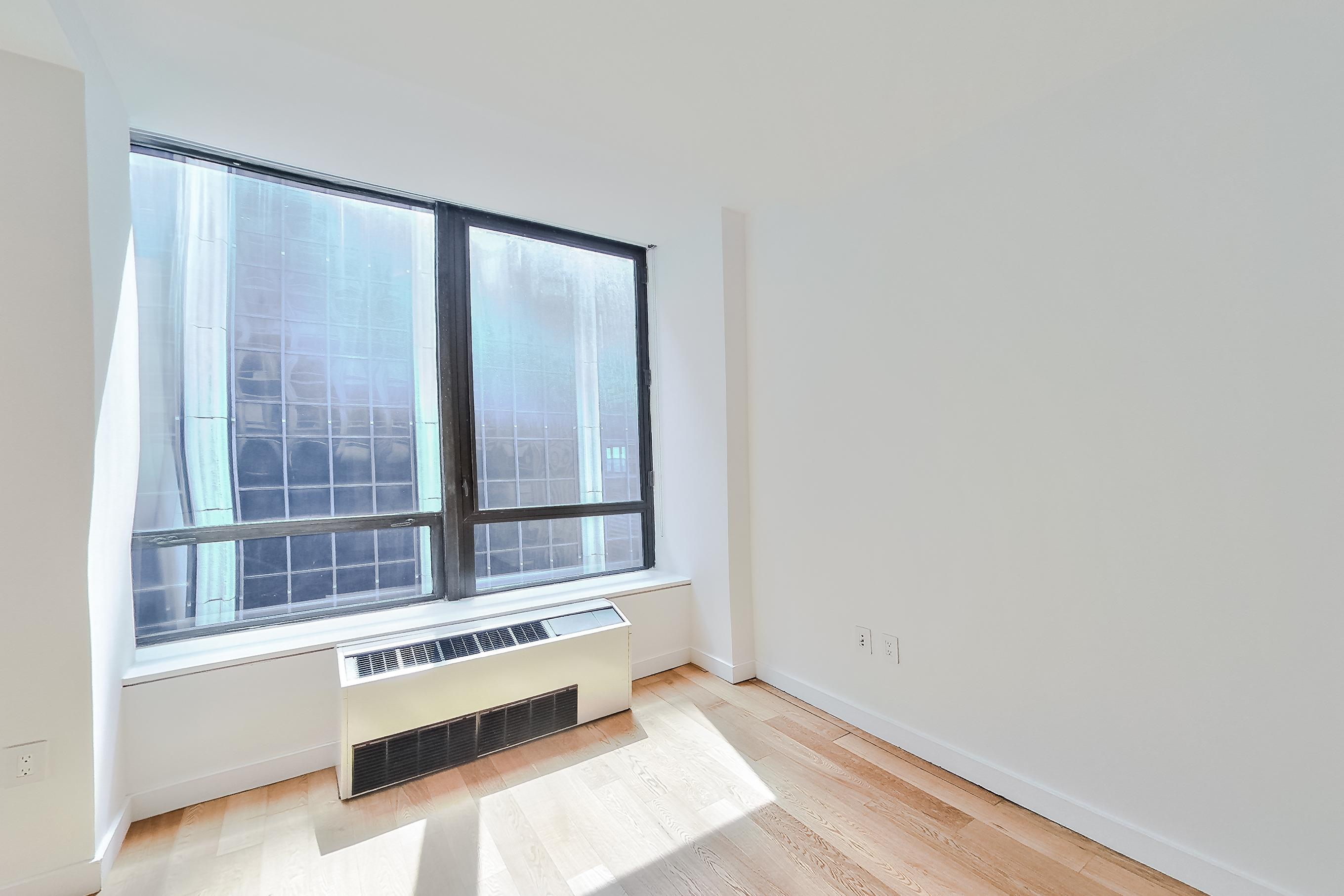 Living space with light wood-finish flooring, Apartment 1805 at Platinum Properties