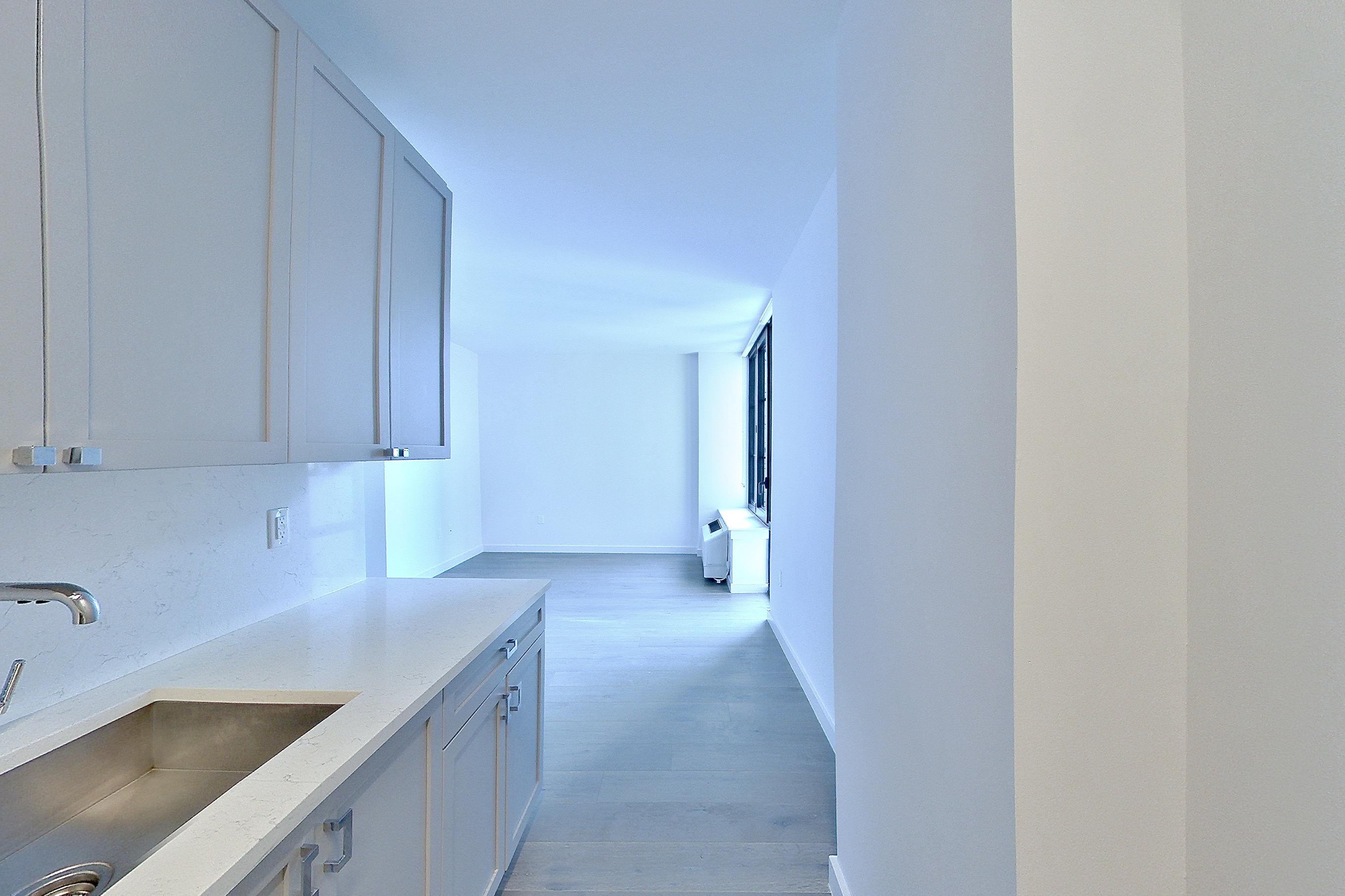 Kitchen with cooktop, gas cooktop, light stone countertops, oven/range, and stainless steel appliances, Apartment 1501 at 1 Flatbush