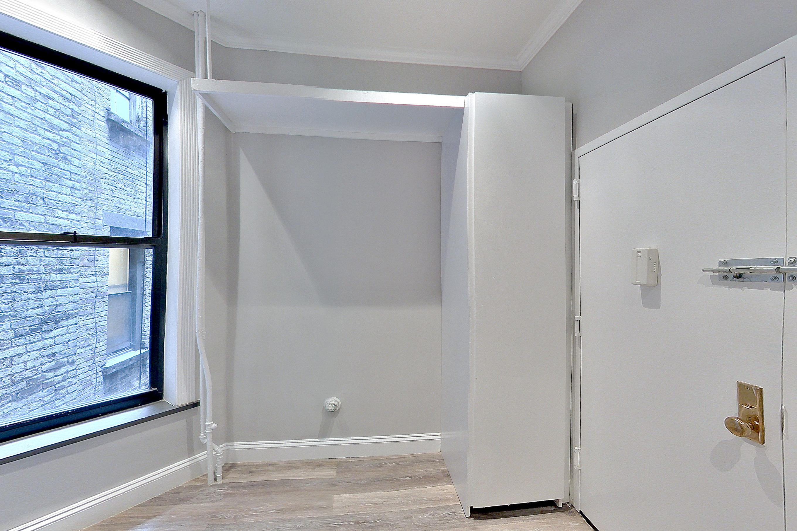 Living space with light wood-finish flooring, Apartment CK at Centennial Properties