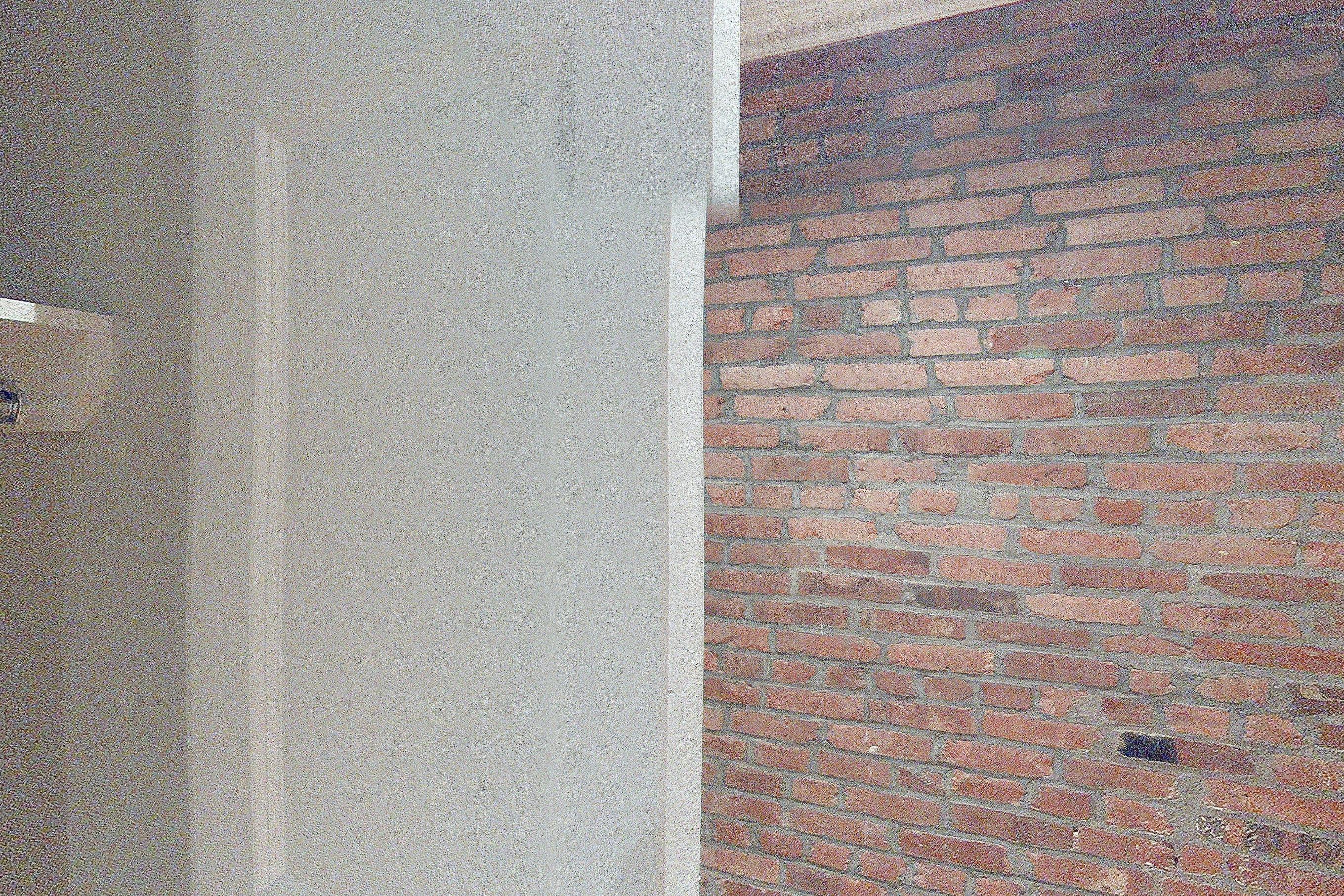 Living room closet with baseboard heating and brick-look tile flooring, Apartment 3 at Centennial Properties