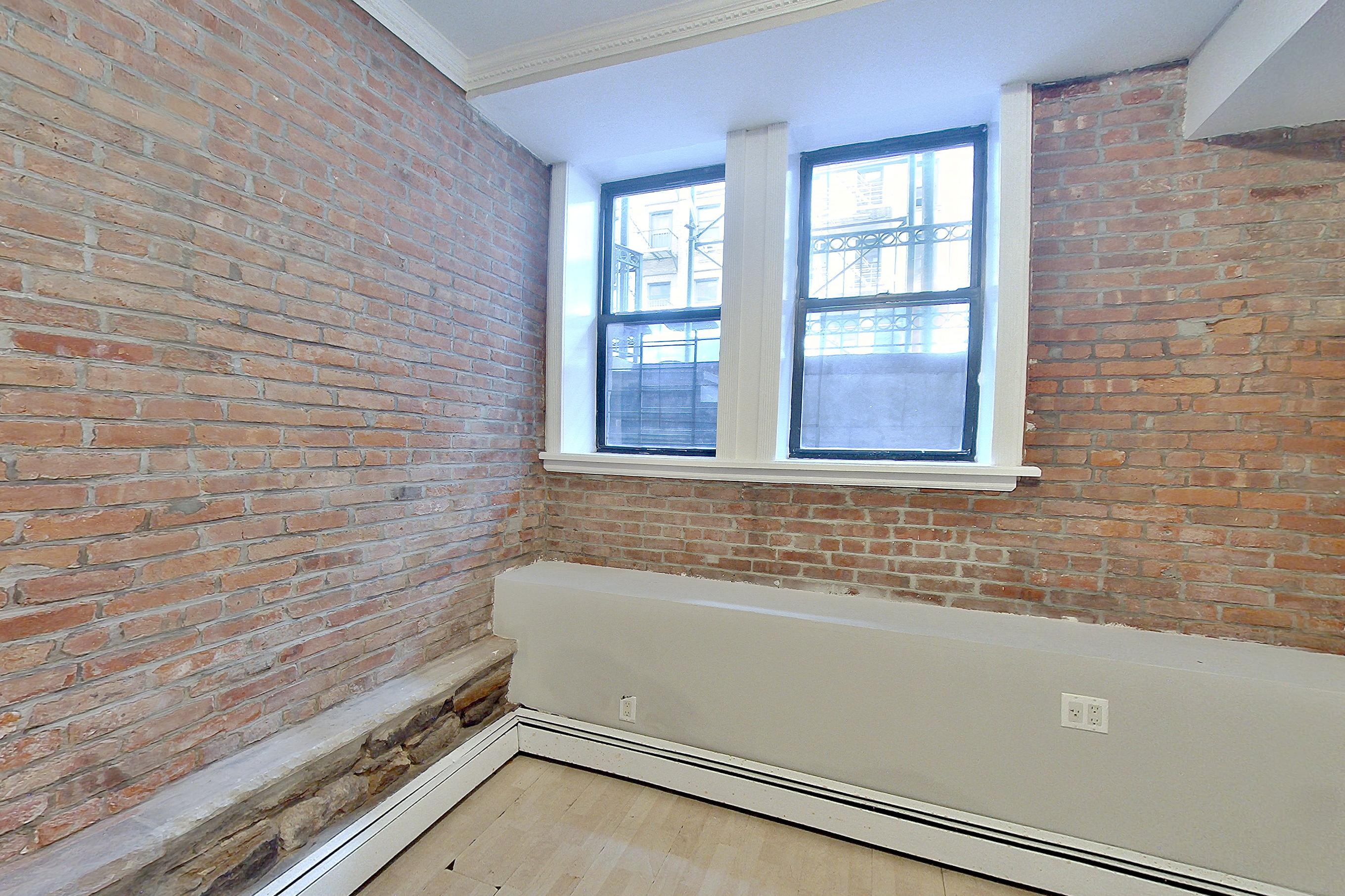 Living room with baseboard heating, brick-look tile flooring, light vinyl flooring, and light wood-finish flooring, Apartment LW at Centennial Properties