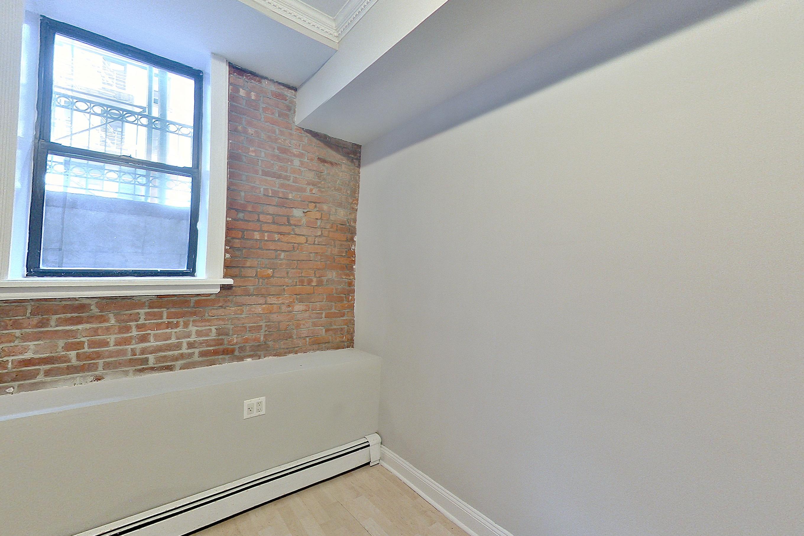 Living room with baseboard heating, brick-look tile flooring, light vinyl flooring, and light wood-finish flooring, Apartment LW at Centennial Properties