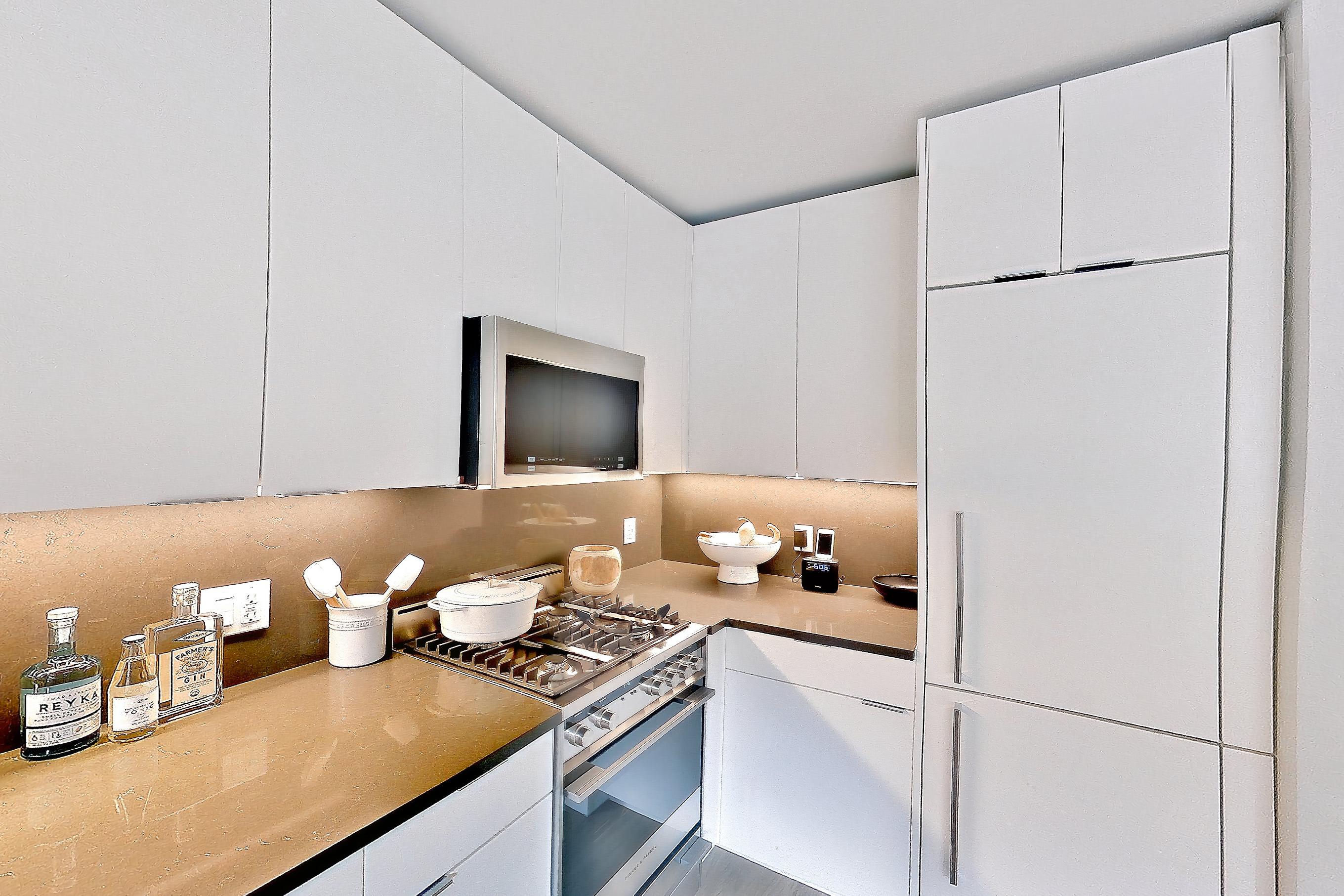 Kitchen with gas range, light wood-finish flooring, oven/range, and stainless steel appliances, Apartment 12 line studio at Hollingsworth