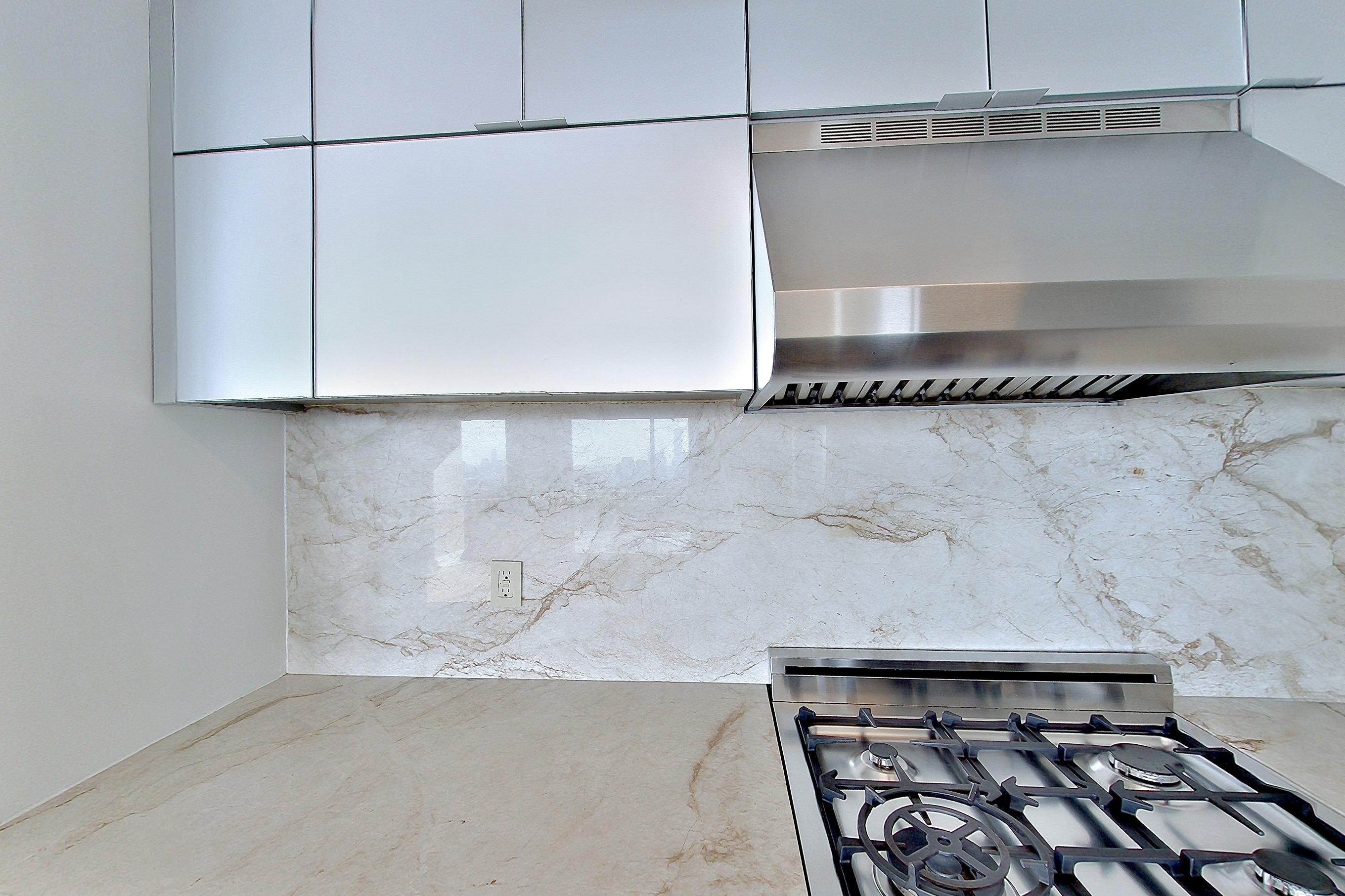 Kitchen with gas range, oven/range, and stainless steel appliances, Apartment 47E at Anagram Nomad
