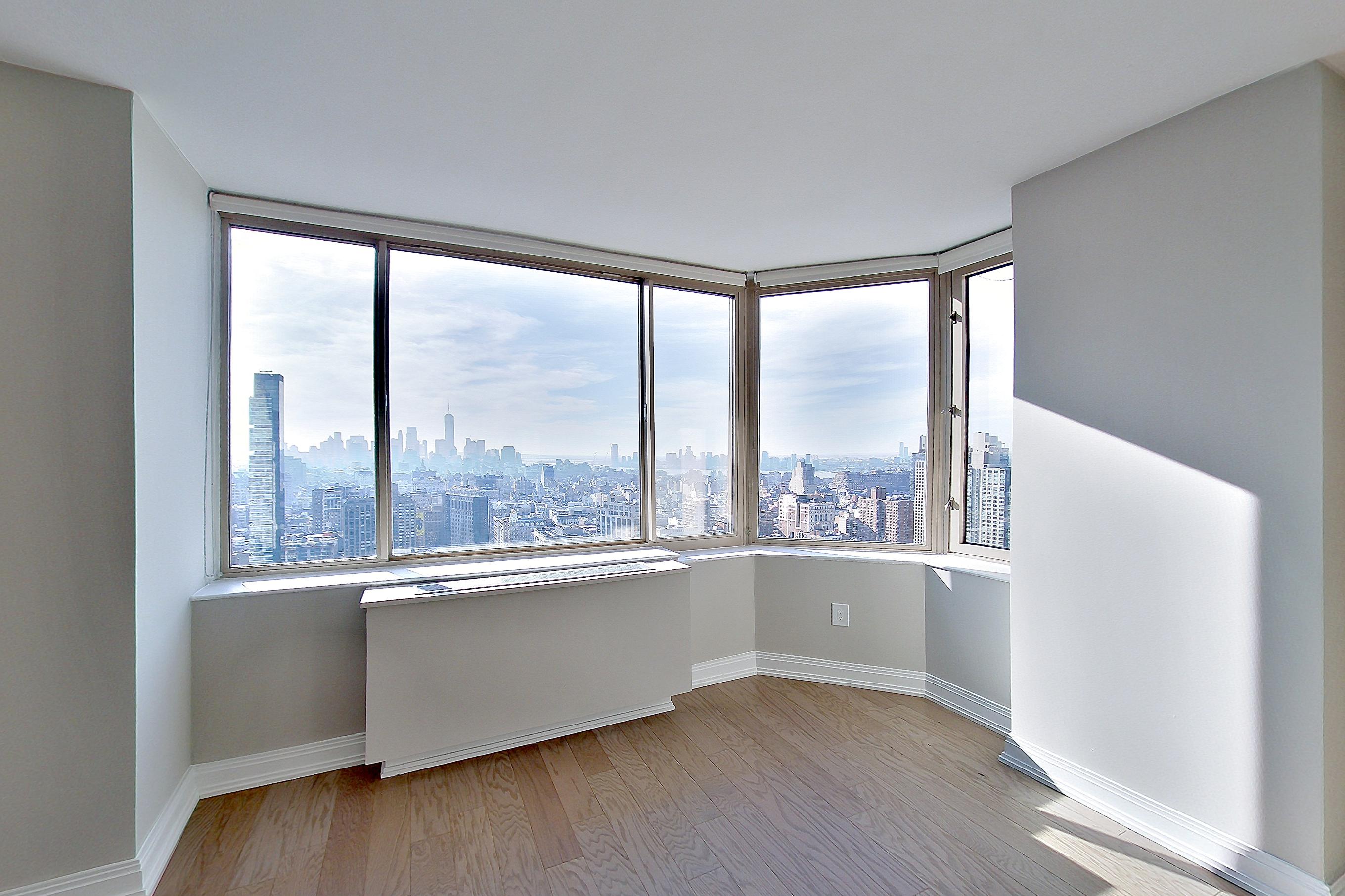 Living room with city view, Apartment 47E at Anagram Nomad