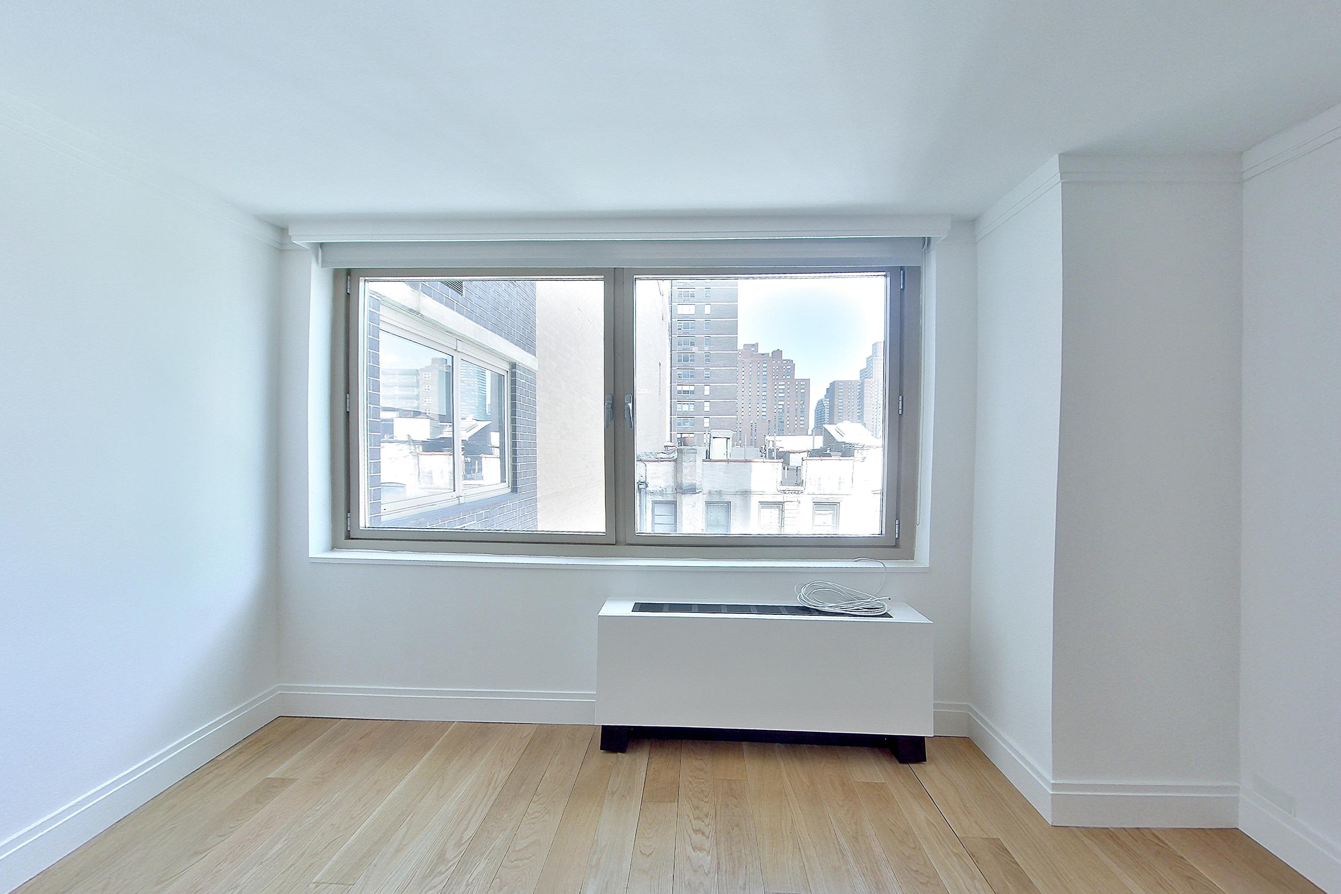 Living room with city view, Apartment 5G at The Colorado