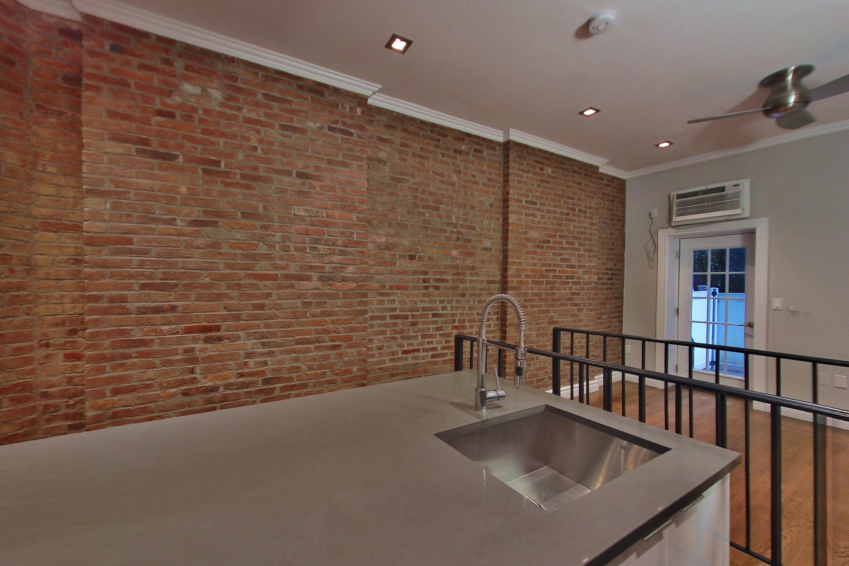 Kitchen with air conditioning and gas range, Apartment 3 at Centennial Properties