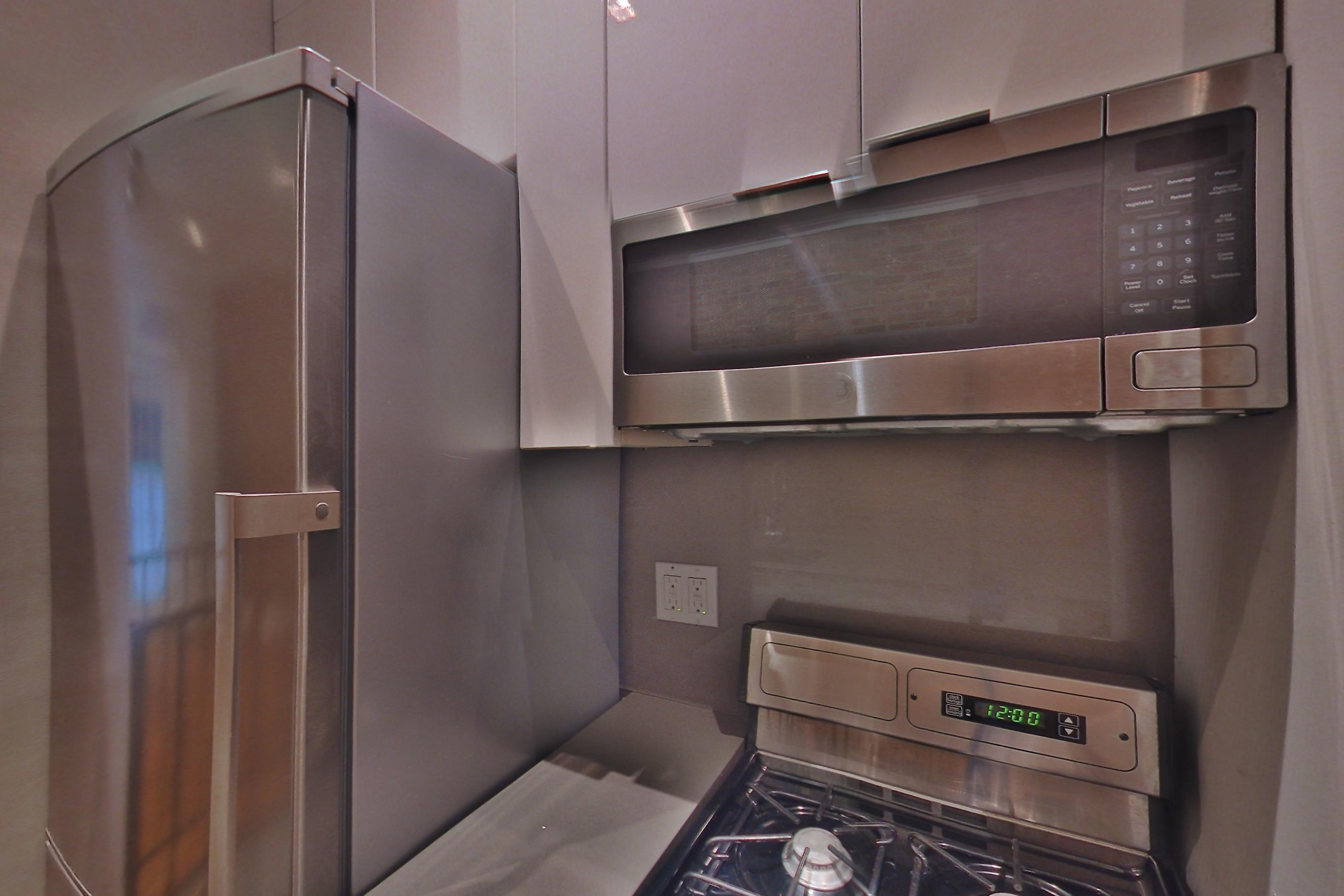 Kitchen with air conditioning and gas range, Apartment 3 at Centennial Properties