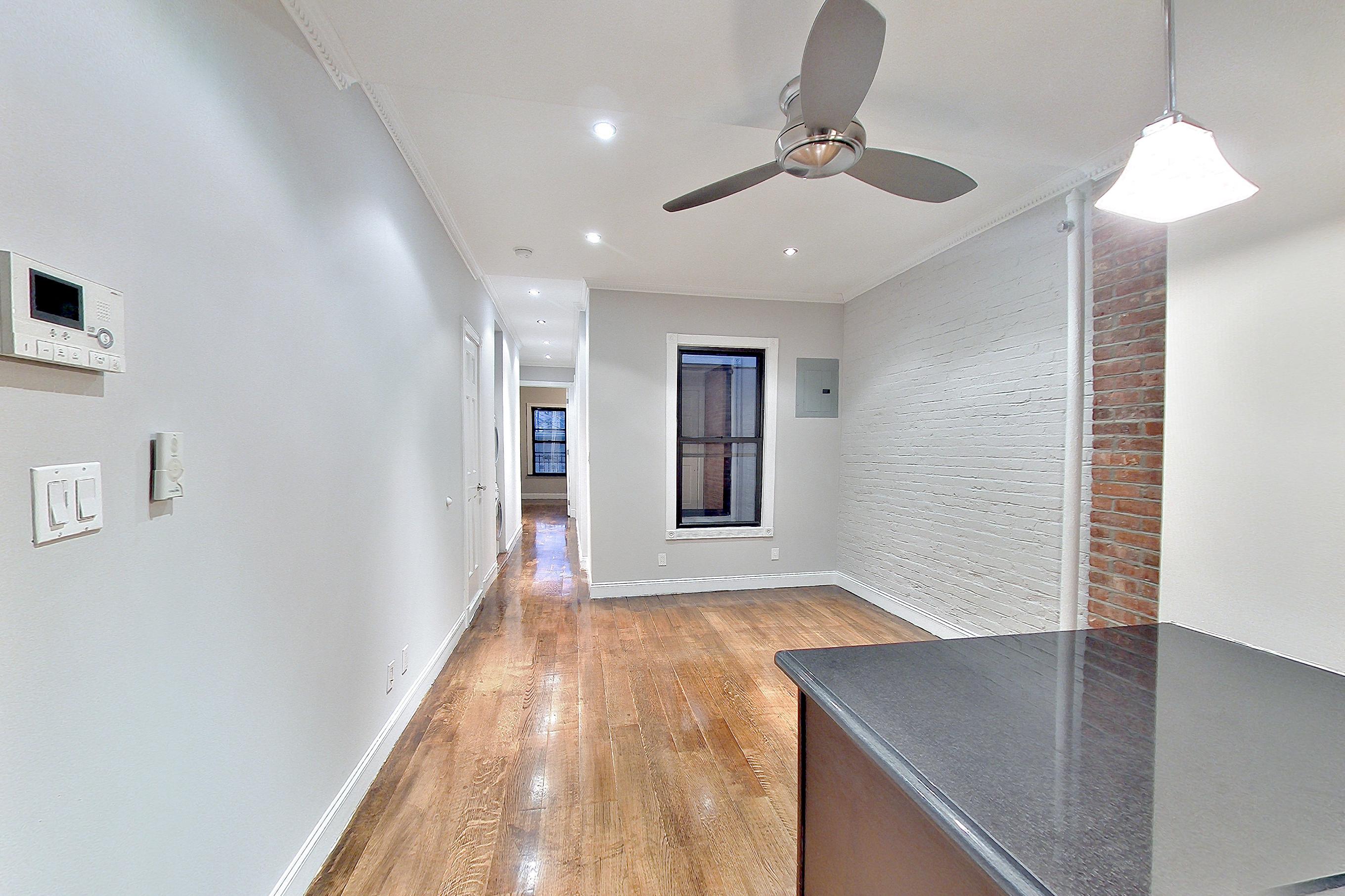 Kitchen with gas range, light wood-finish flooring, oven/range, stainless steel appliances, and wood-finish flooring, Apartment 13E at Centennial Properties