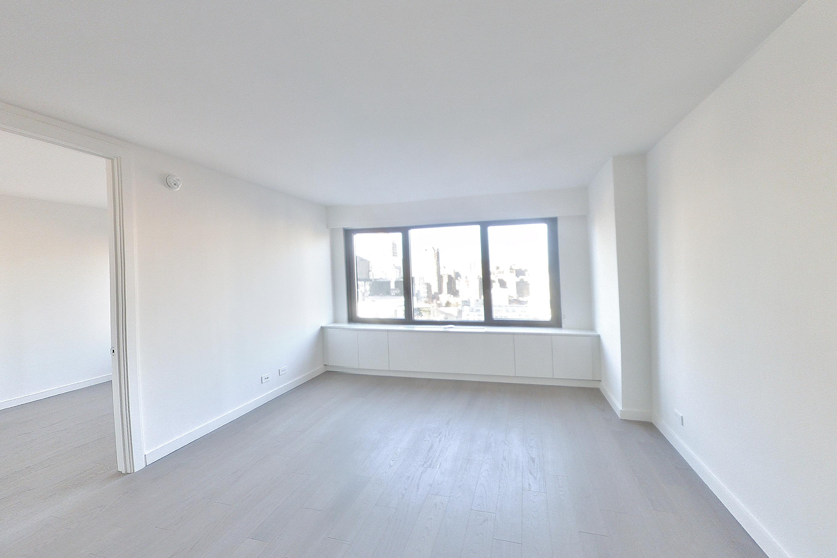 Living room with light wood-finish flooring, Apartment 19E at 220 East 72nd