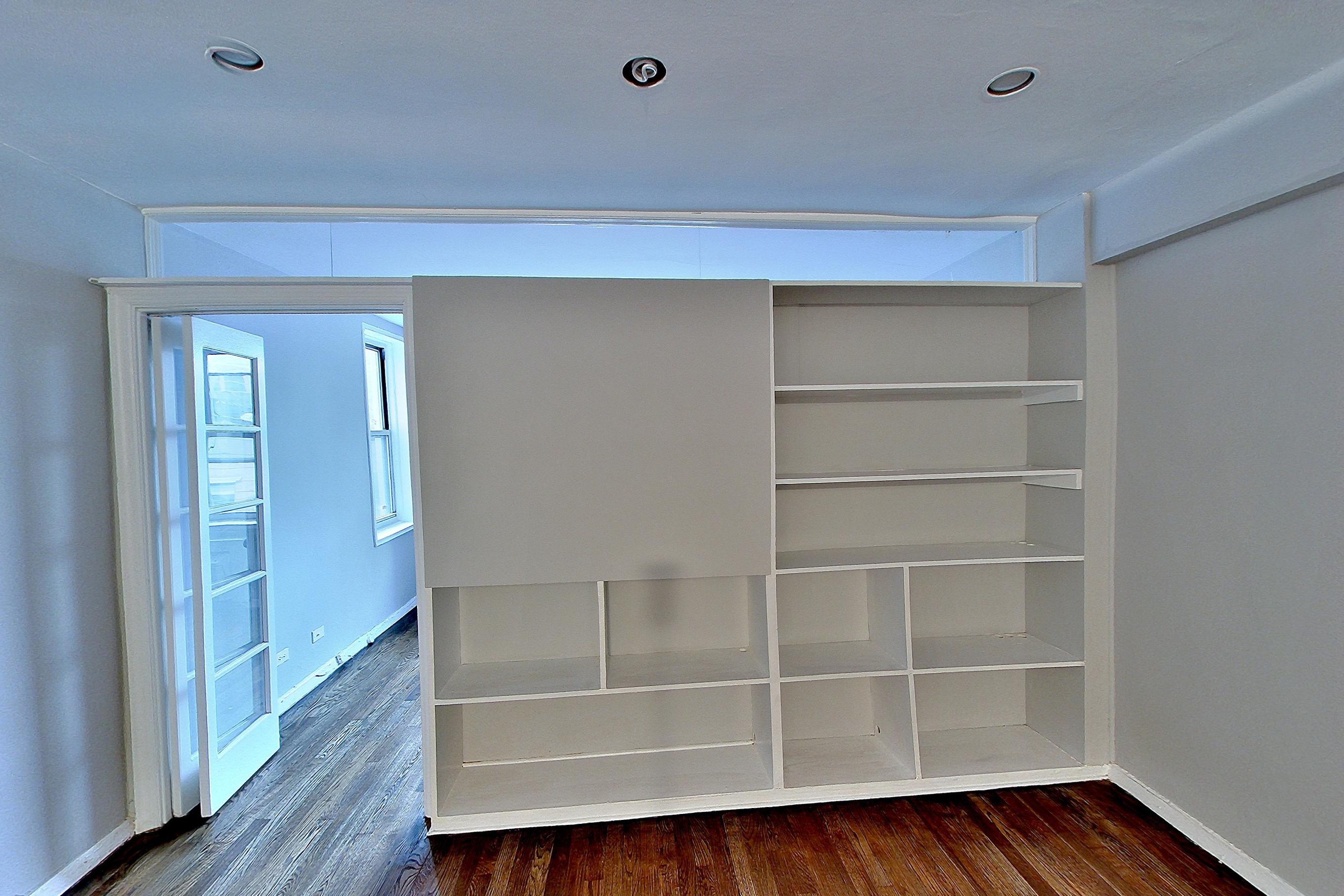 Living area with dark wood-finish flooring, Apartment 6a at Centennial Properties