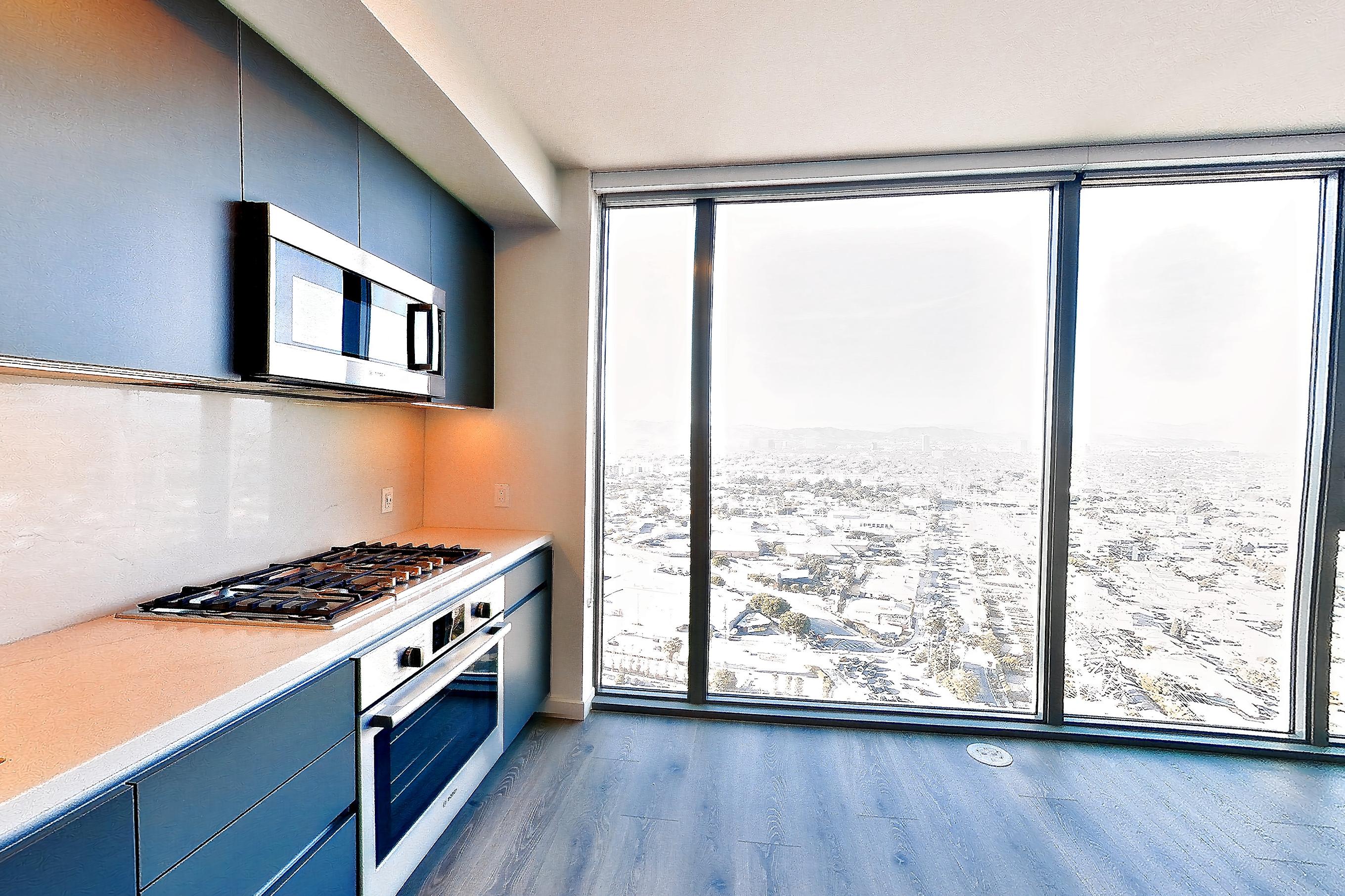 Kitchen with cooktop, gas cooktop, light stone countertops, oven/range, and stainless steel appliances, Apartment 2806 at ARQ