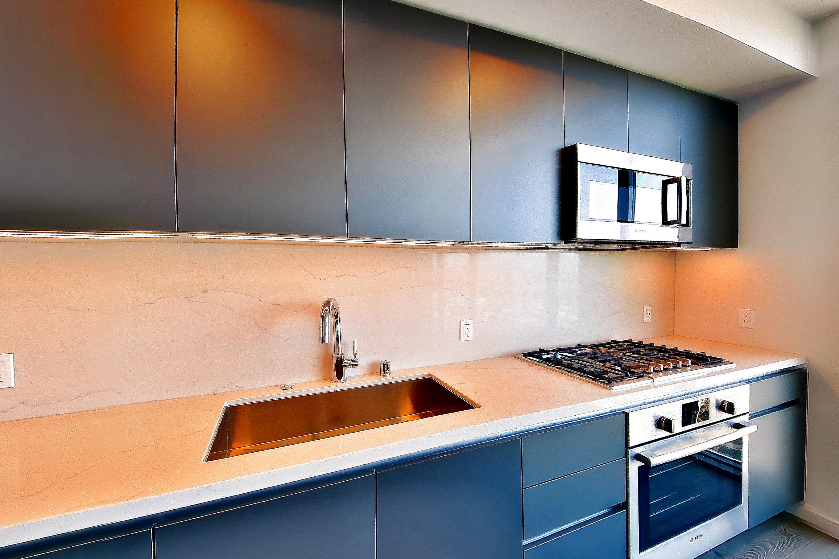 Kitchen with cooktop, gas cooktop, light stone countertops, oven/range, and stainless steel appliances, Apartment 2806 at ARQ