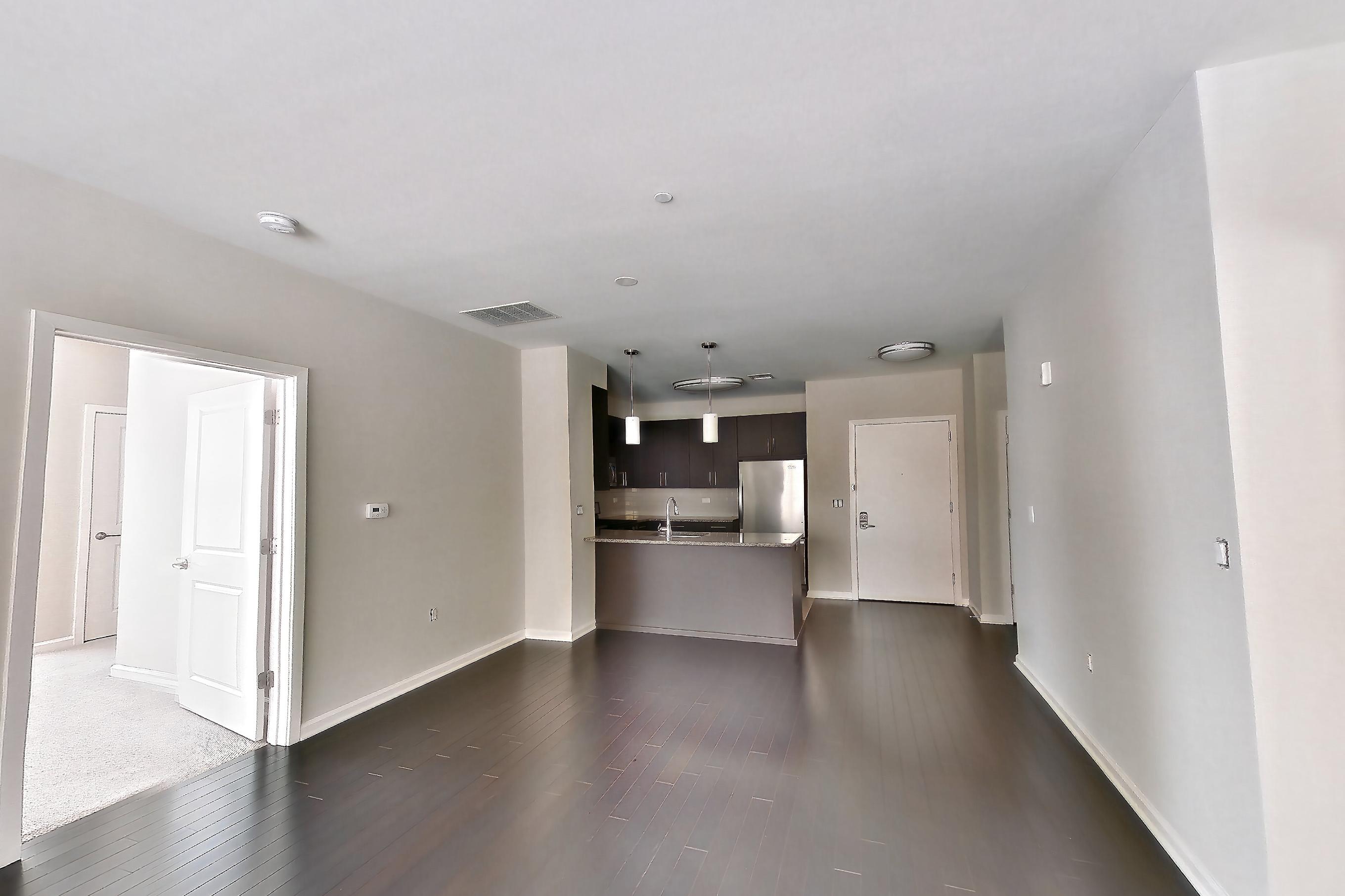 Living room with dark wood-finish flooring, Apartment 1111 at Quarry Place Tuckahoe