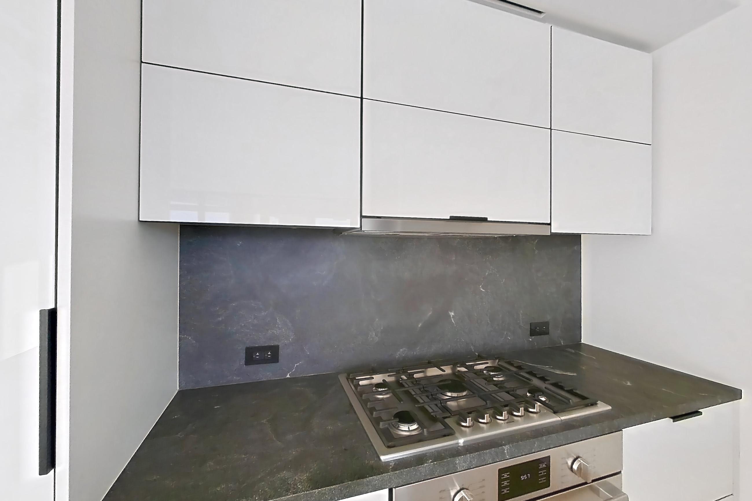 Kitchen with cooktop, dark stone countertops, gas cooktop, oven/range, and stainless steel appliances, Apartment PH2-C at The Bellslip