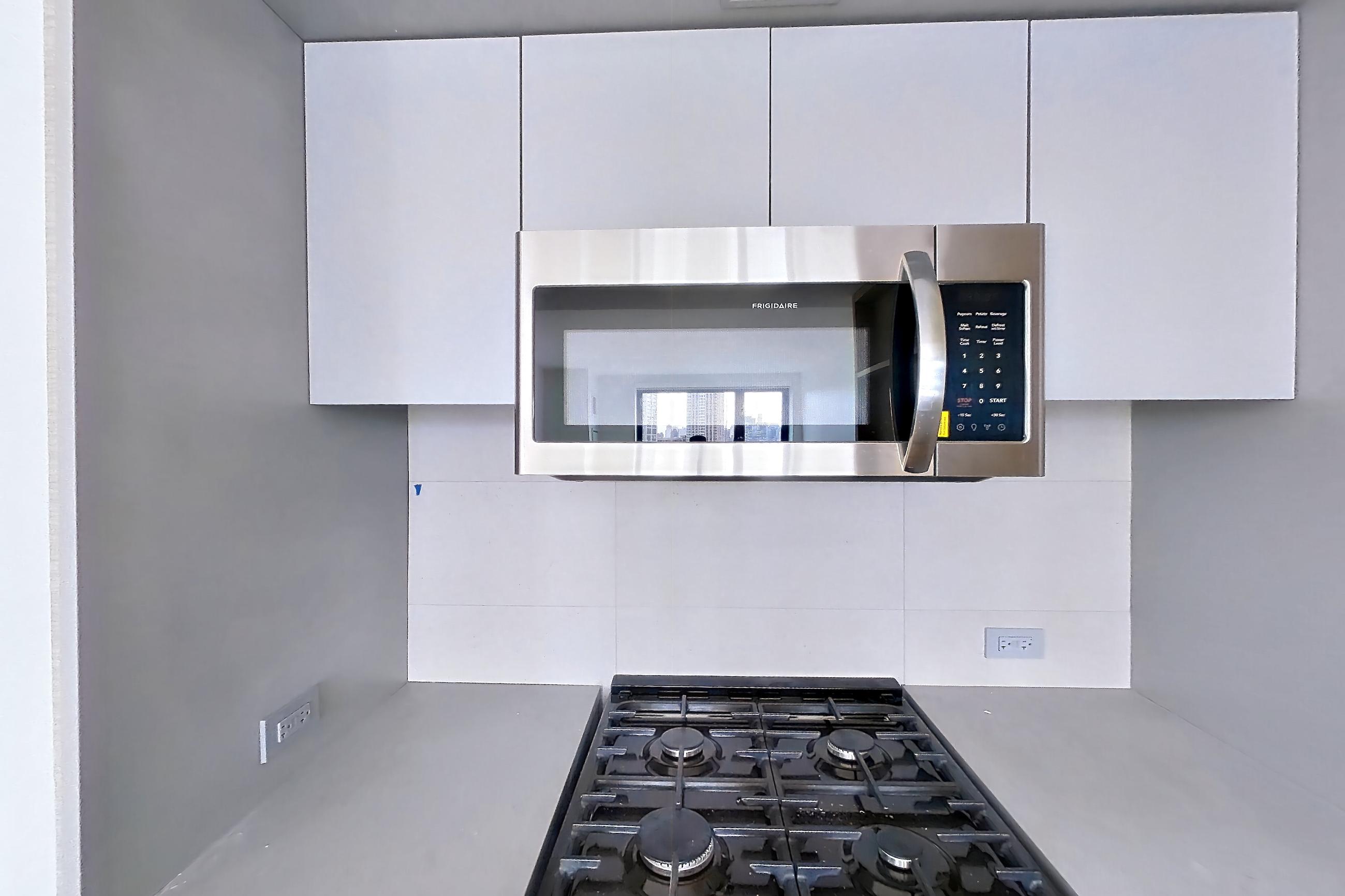 Kitchen with gas range, oven/range, and stainless steel appliances, Apartment 1025 at Eagle + West