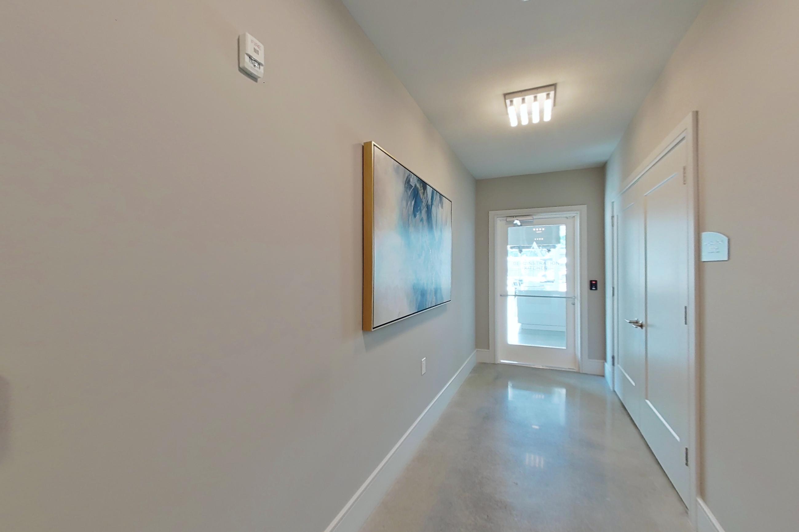 Demonstration kitchen and doggie spa entry with polished concrete flooring, Apartment LOBBY at Amaranth at North Brunswick