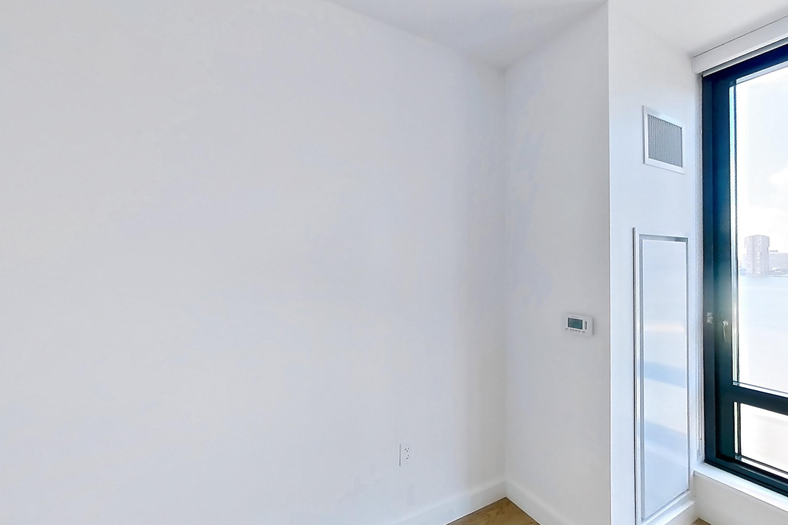 Living room with city view, gas range, light wood-finish flooring, oven/range, and stainless steel appliances, Apartment 0-08H at The Bellslip