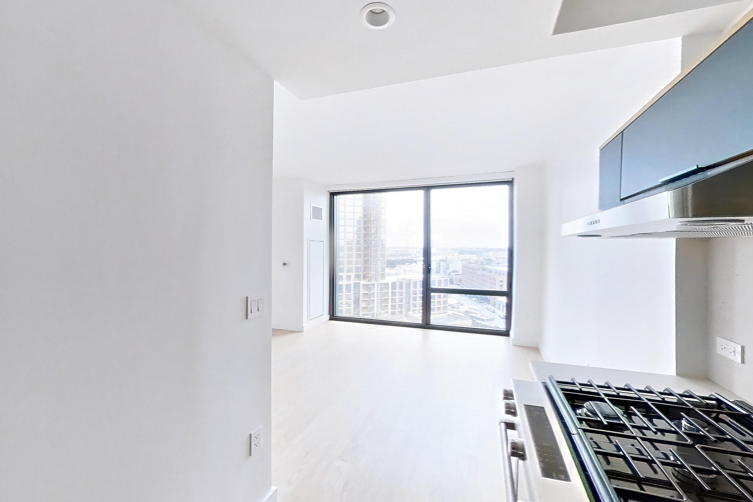 Kitchen with light wood-finish flooring, Apartment 0-11D at The Bellslip