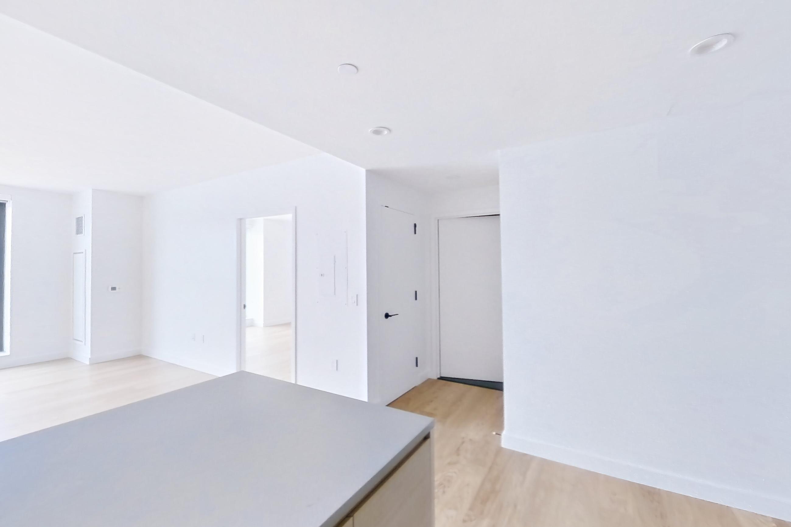 Kitchen with gas range and light wood-finish flooring, Apartment 1025(2) at Eagle + West