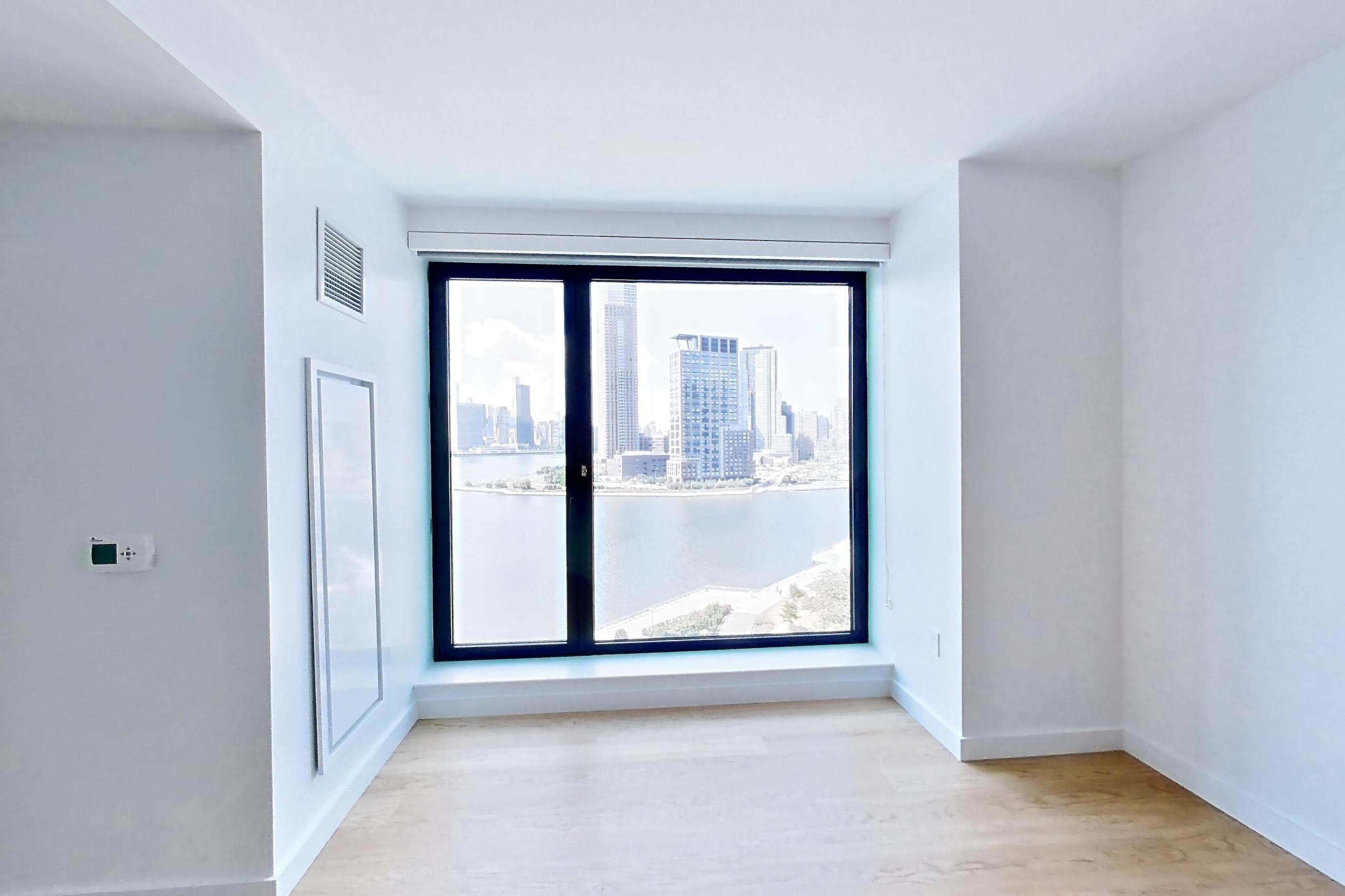 Living room with light wood-finish flooring, Apartment 1026 at Eagle + West