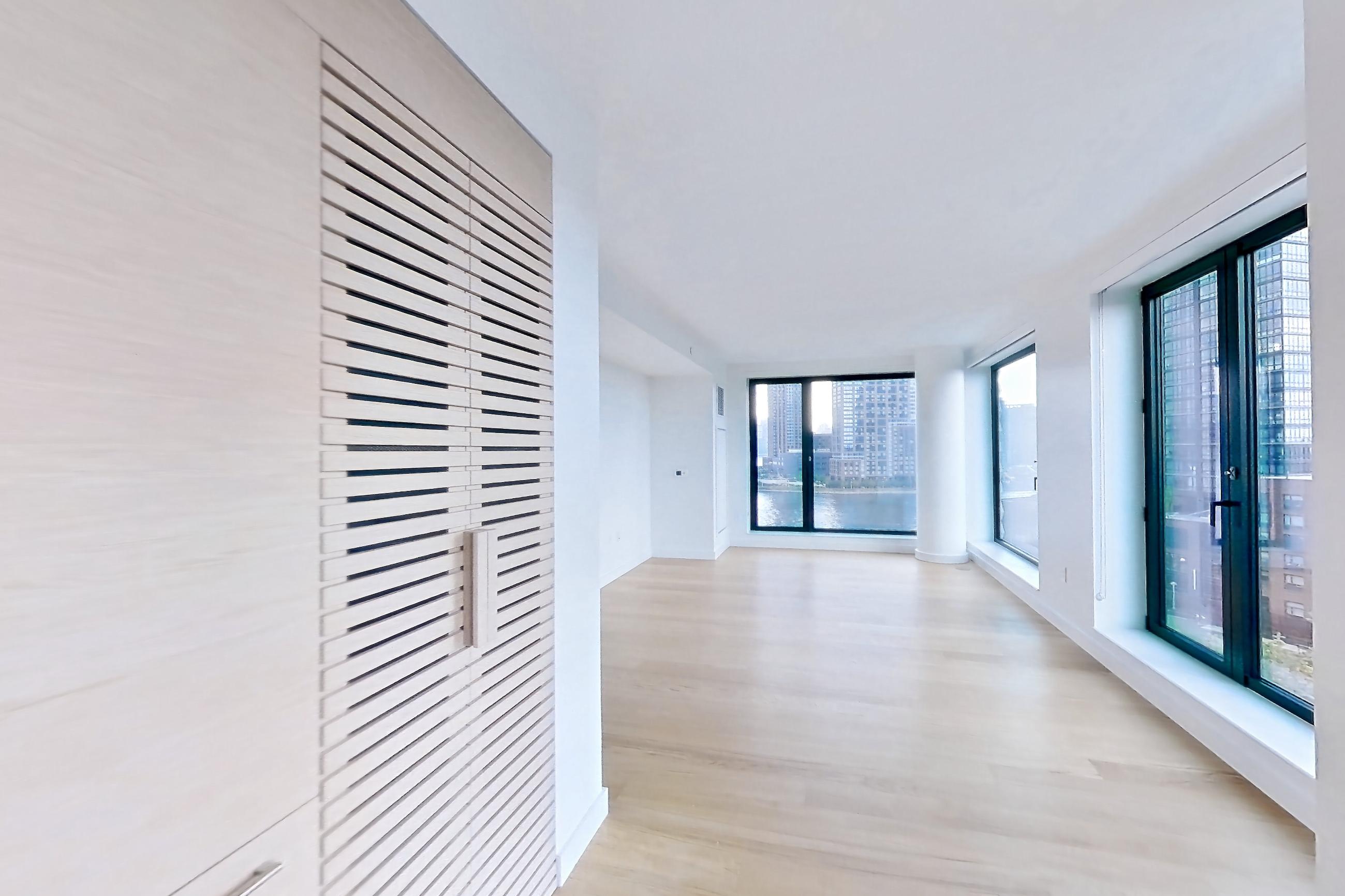 Kitchen with city view and light wood-finish flooring, Apartment 2-0822 at Eagle + West