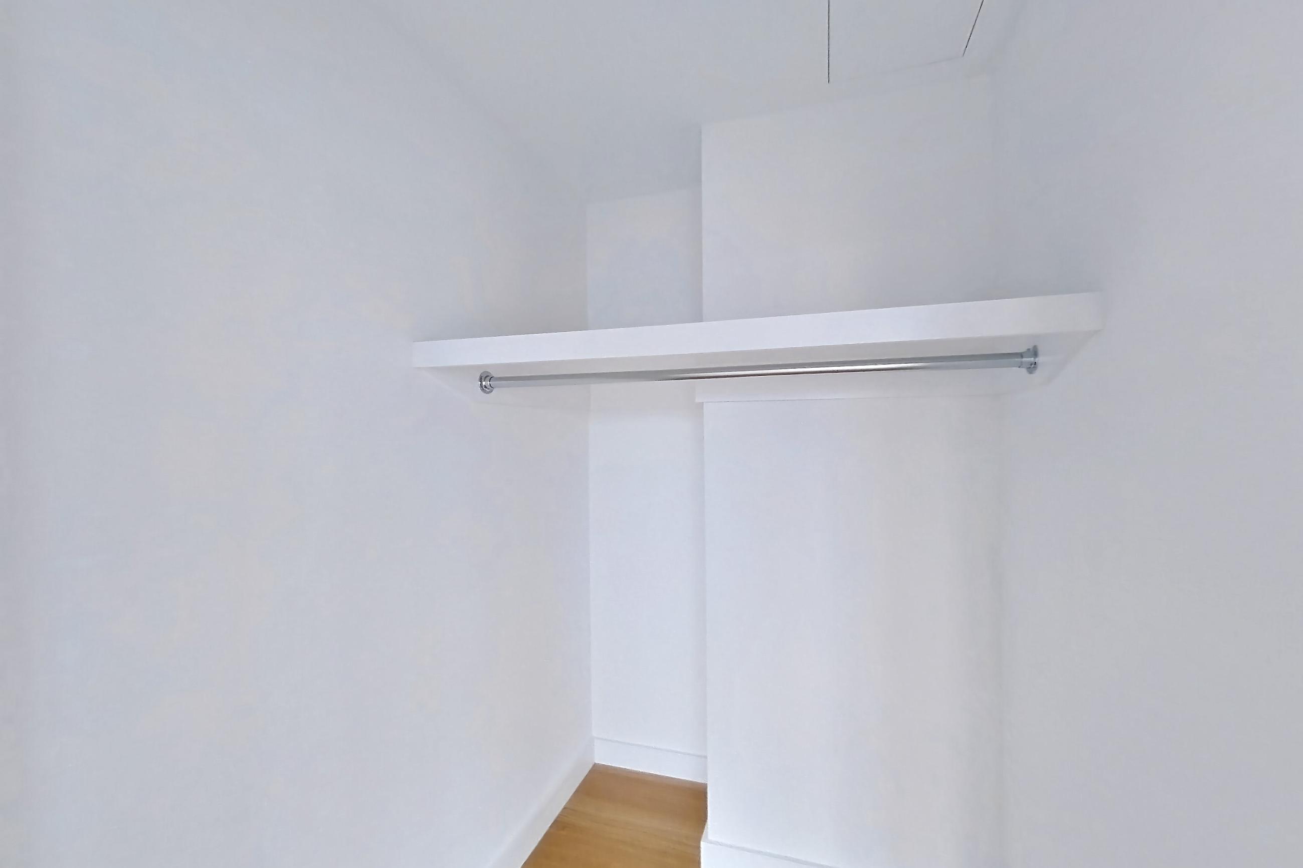 Living space closet with light wood-finish flooring, Apartment 2-0824 at Eagle + West