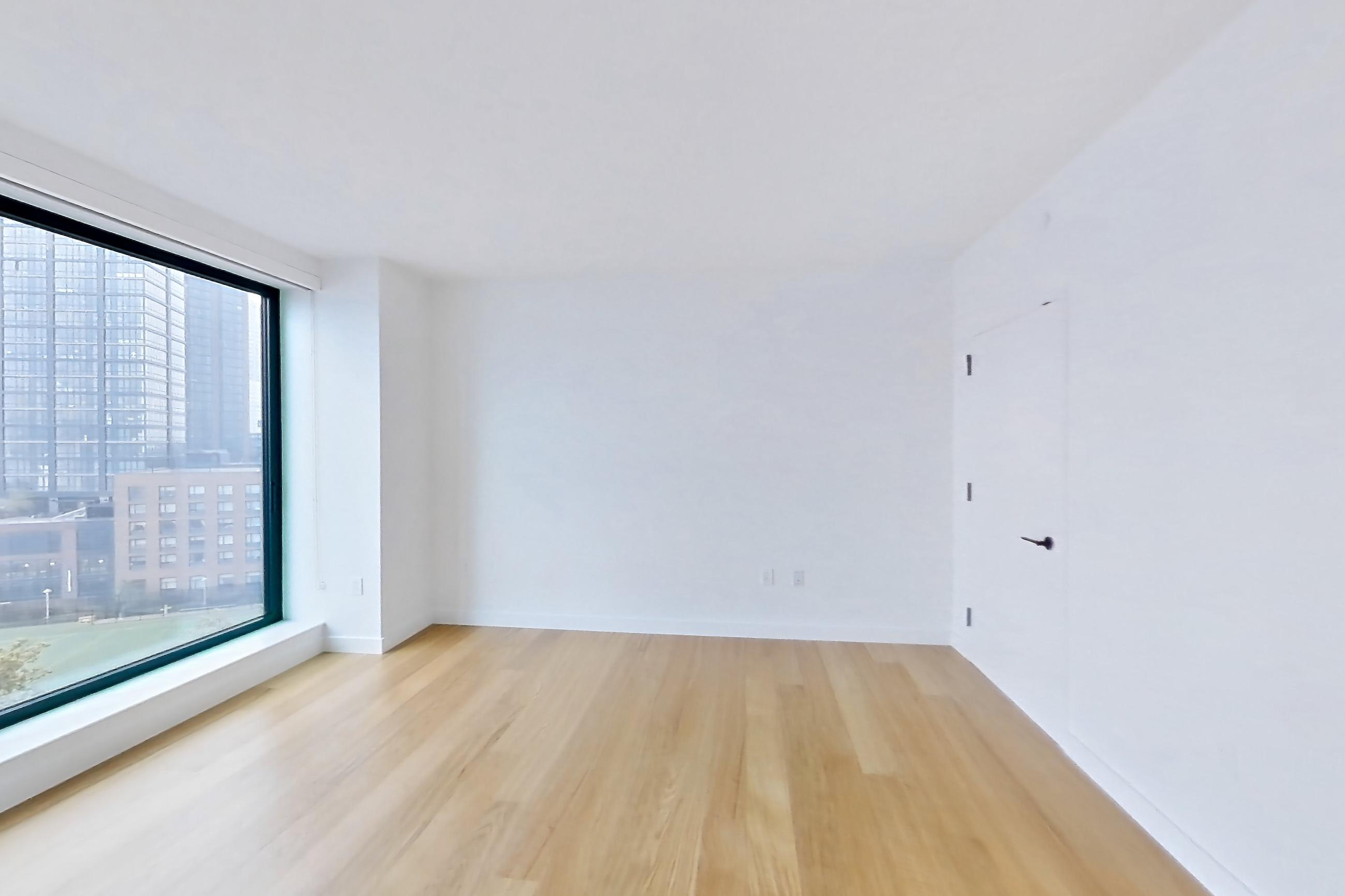 Living space with light wood-finish flooring, Apartment 2-0824 at Eagle + West