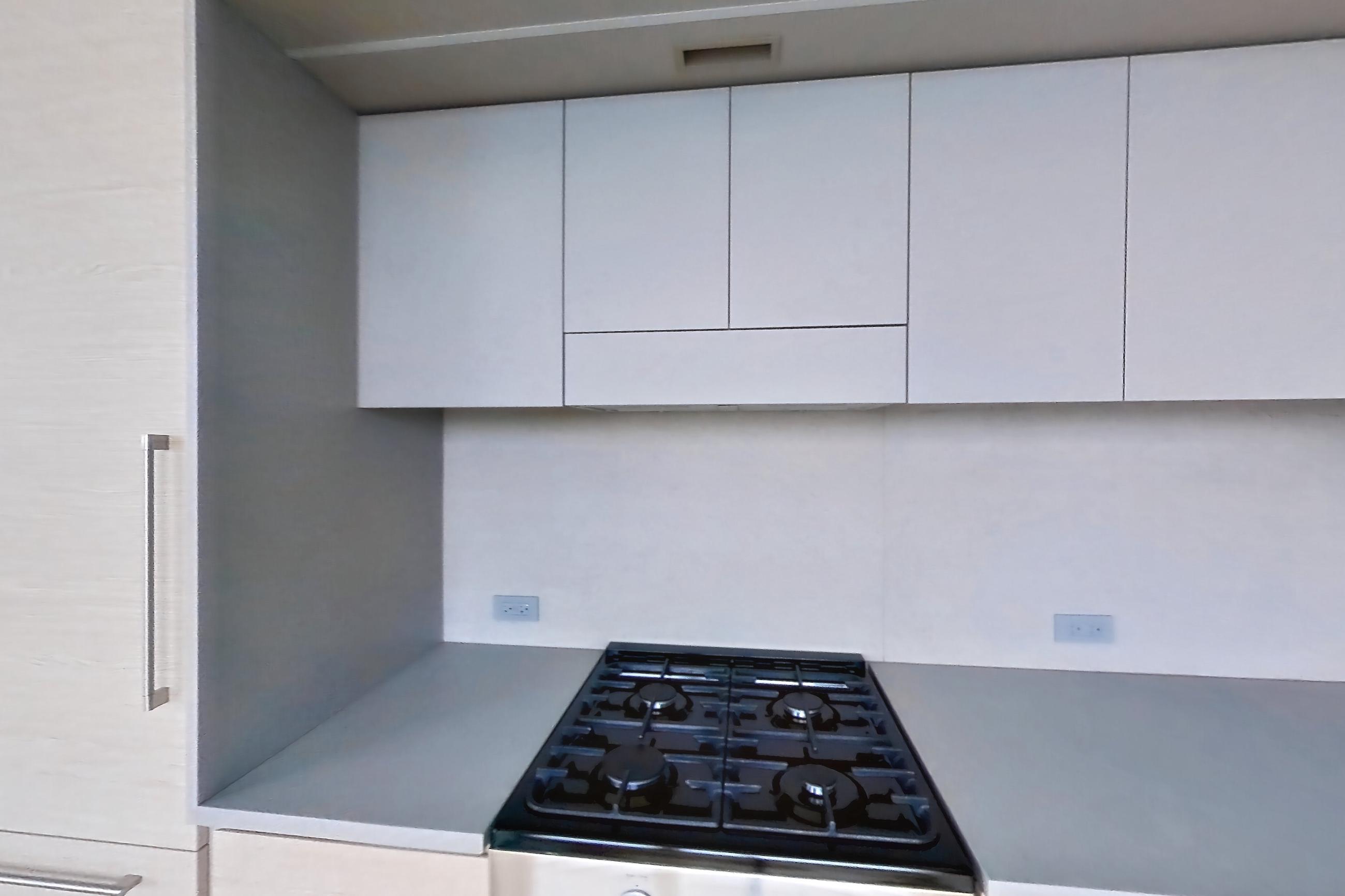 Kitchen with city view, gas range, and light wood-finish flooring, Apartment 2-1521 at Eagle + West