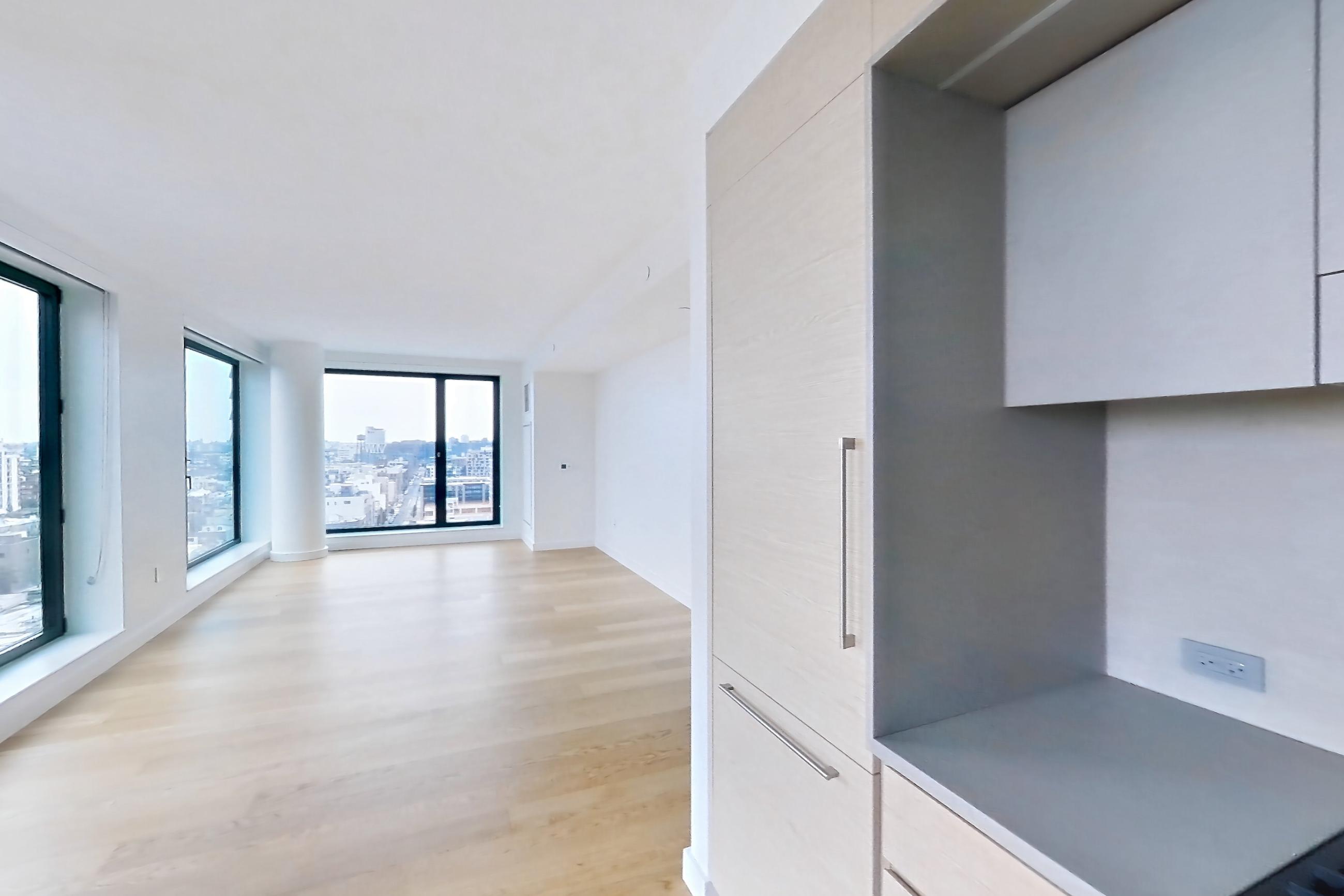 Kitchen with city view, gas range, and light wood-finish flooring, Apartment 2-1521 at Eagle + West
