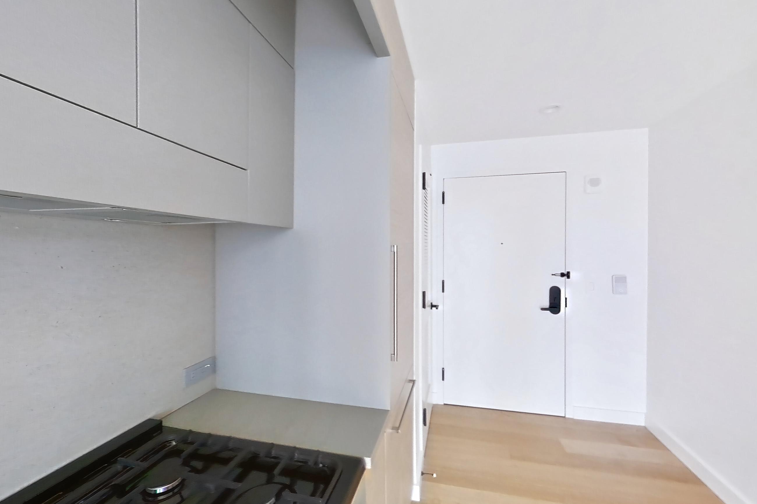Kitchen with black appliances, gas range, light wood-finish flooring, and oven/range, Apartment 2-1523 at Eagle + West