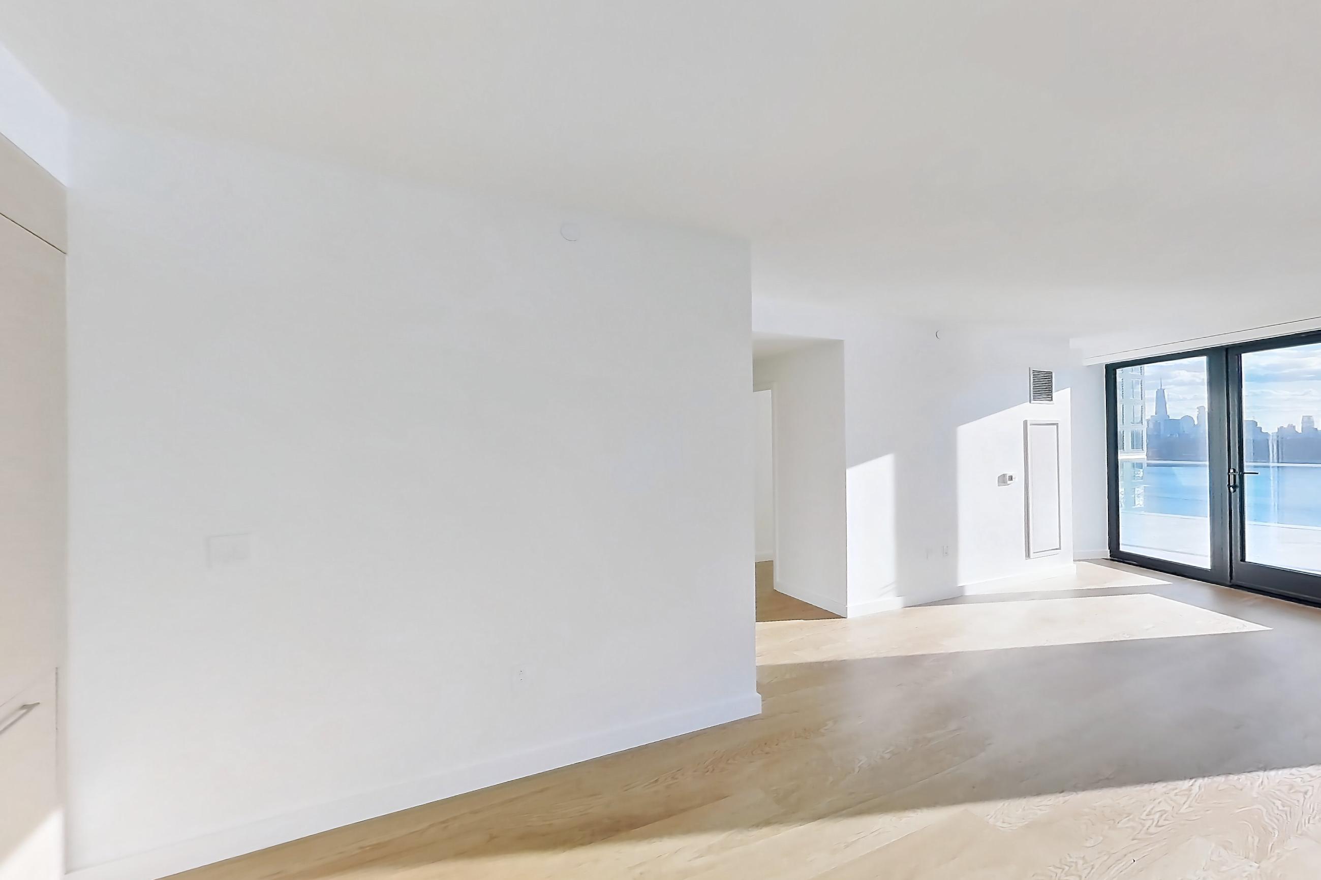 Kitchen with city view, gas range, light wood-finish flooring, oven/range, skyline view, and stainless steel appliances, Apartment 2-1526 at Eagle + West