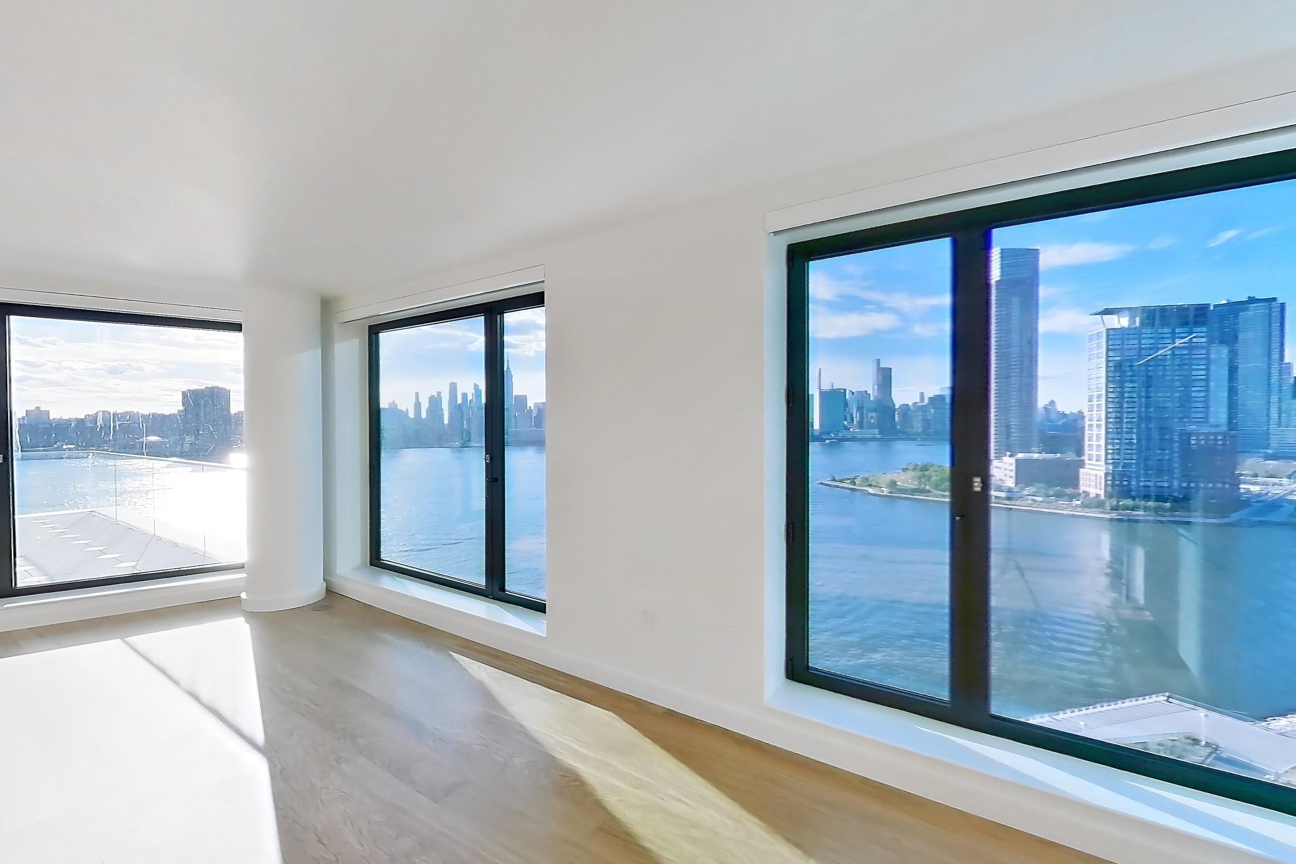 Kitchen with city view, gas range, light wood-finish flooring, oven/range, skyline view, and stainless steel appliances, Apartment 2-1526 at Eagle + West