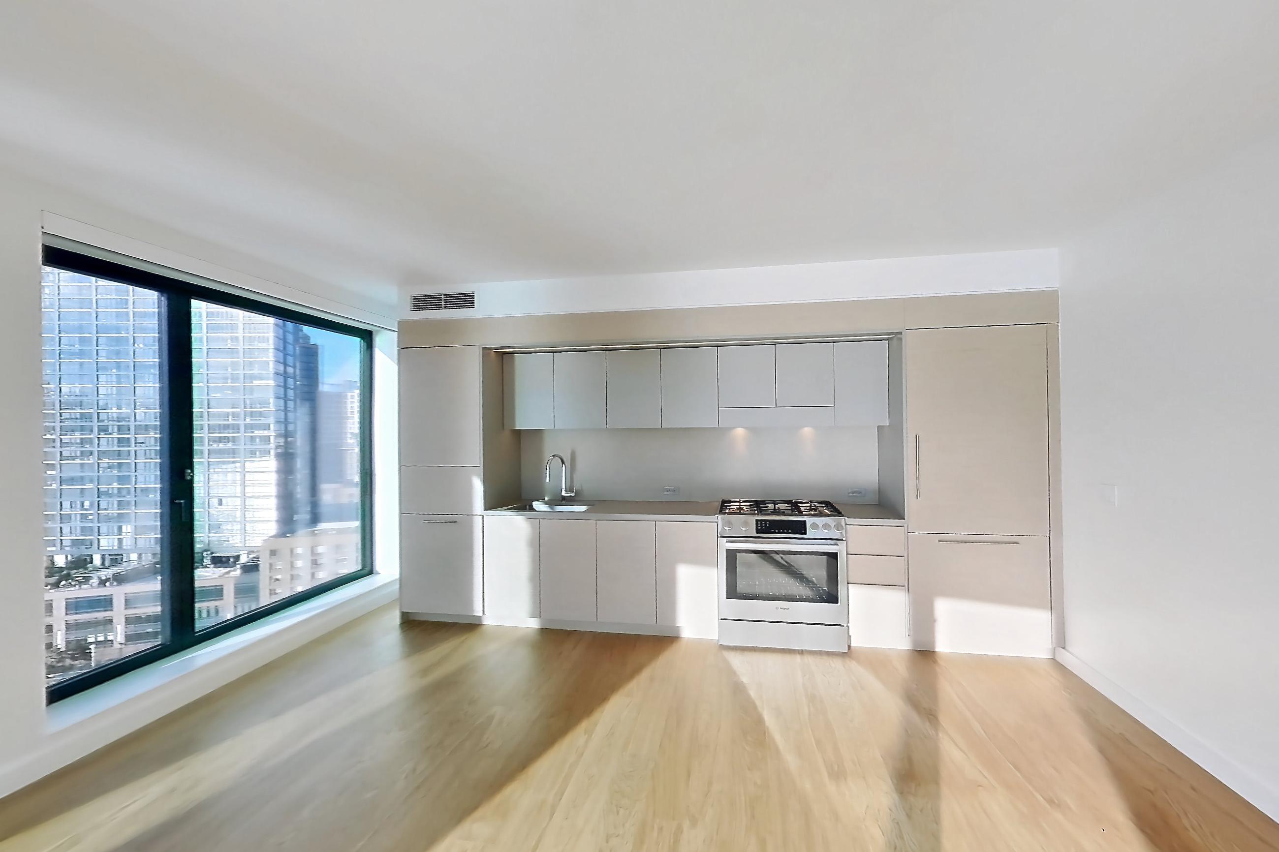 Living room with city view, gas range, light wood-finish flooring, oven/range, skyline view, and stainless steel appliances, Apartment 2-1526 at Eagle + West