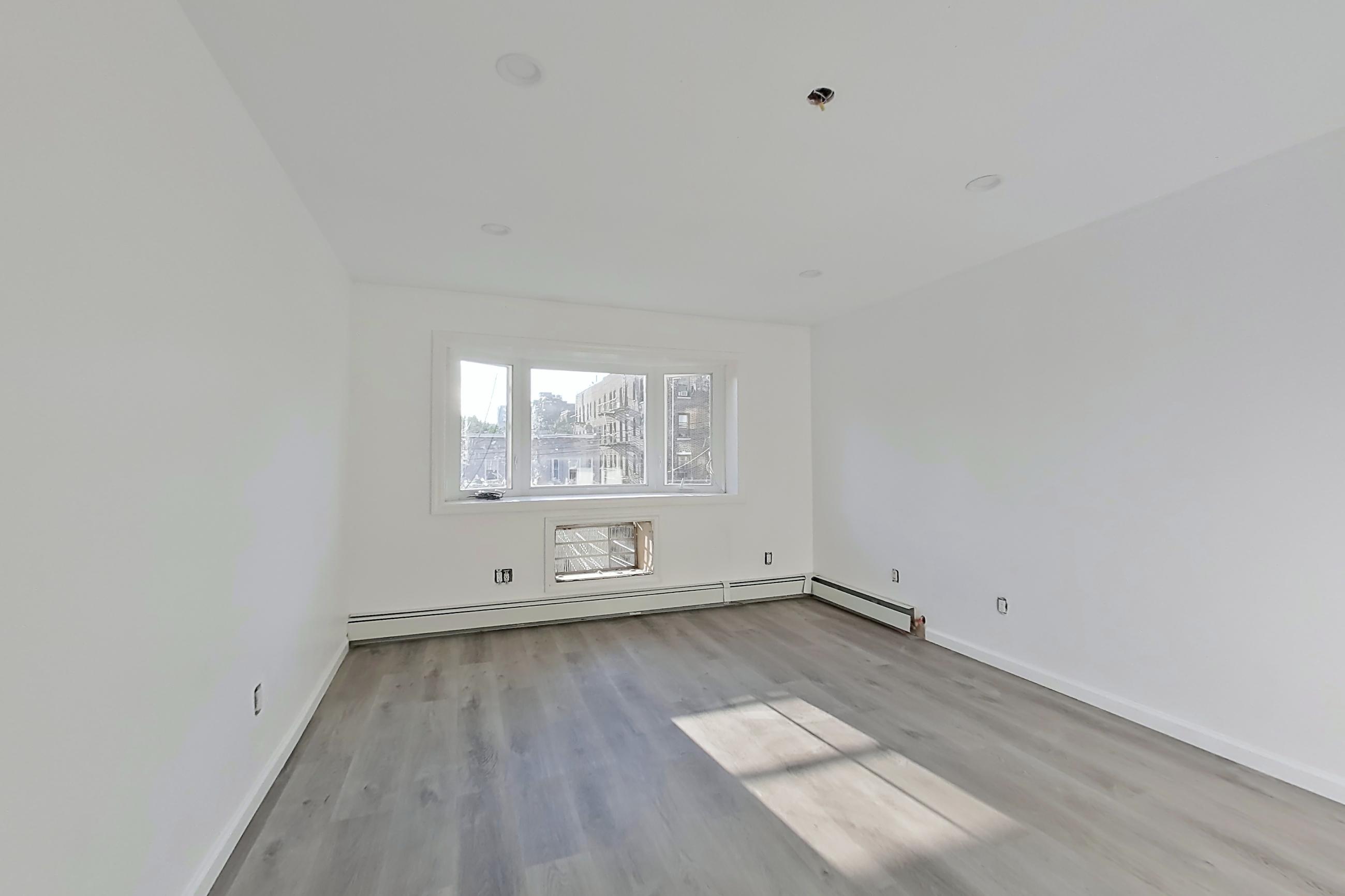 Living room with baseboard heating, Apartment 03 at Platinum Properties