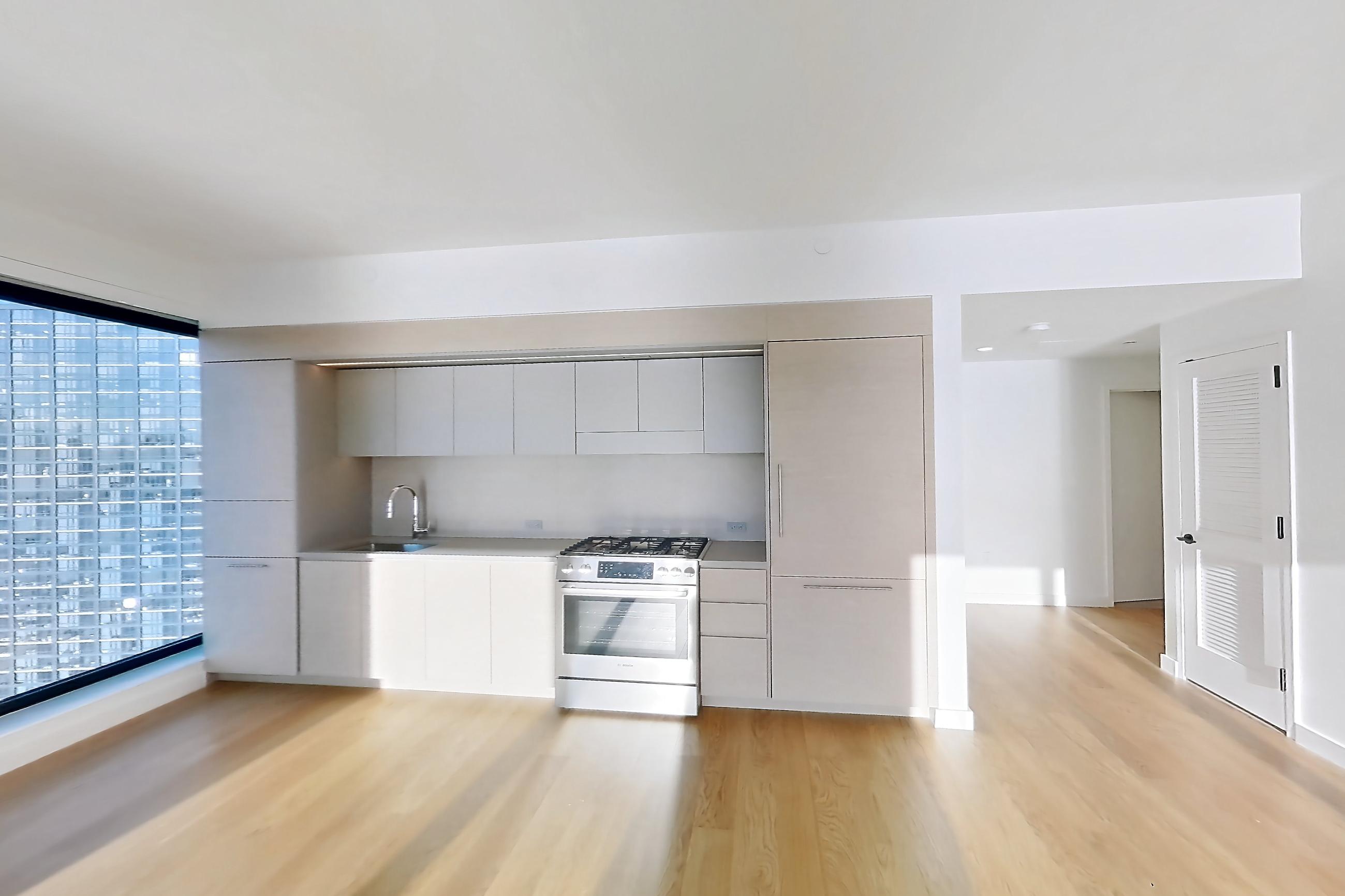 Living room with gas range, light wood-finish flooring, oven/range, and stainless steel appliances, Apartment 2-2626 at Eagle + West