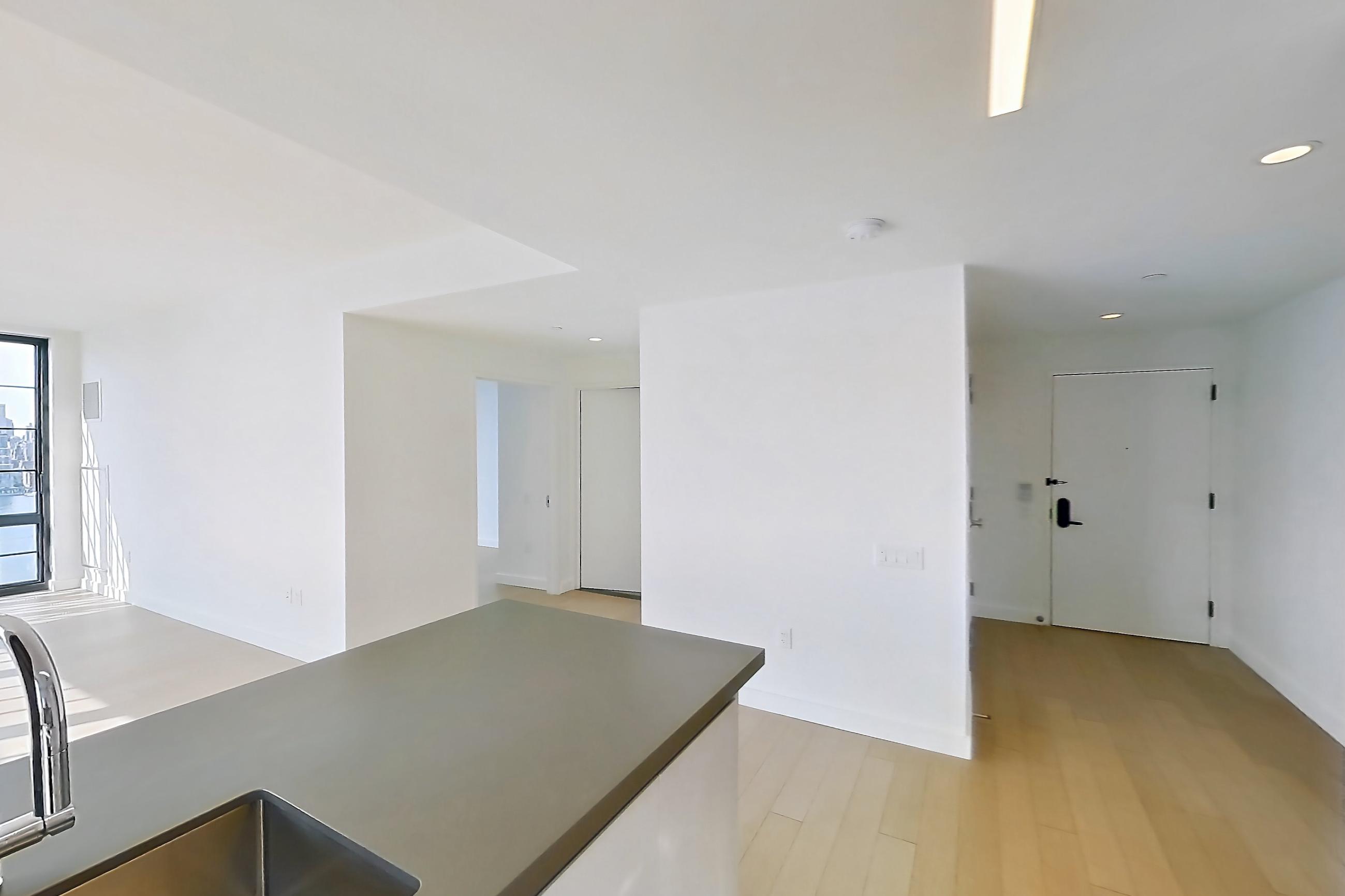 Kitchen with gas range, light wood-finish flooring, oven/range, and stainless steel appliances, Apartment 0-28C at One Blue Slip