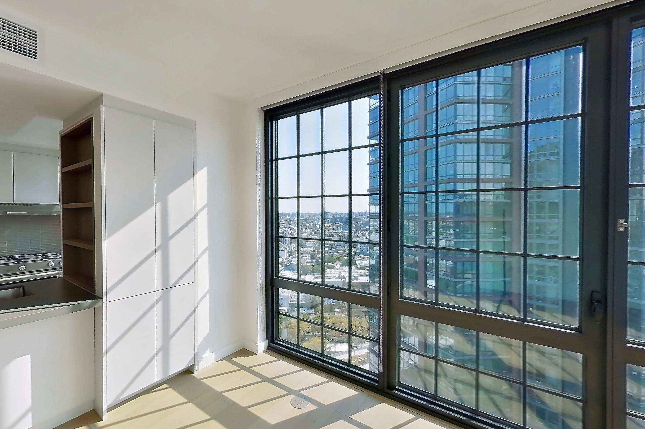 Living room with city view, Apartment 0-28C at One Blue Slip