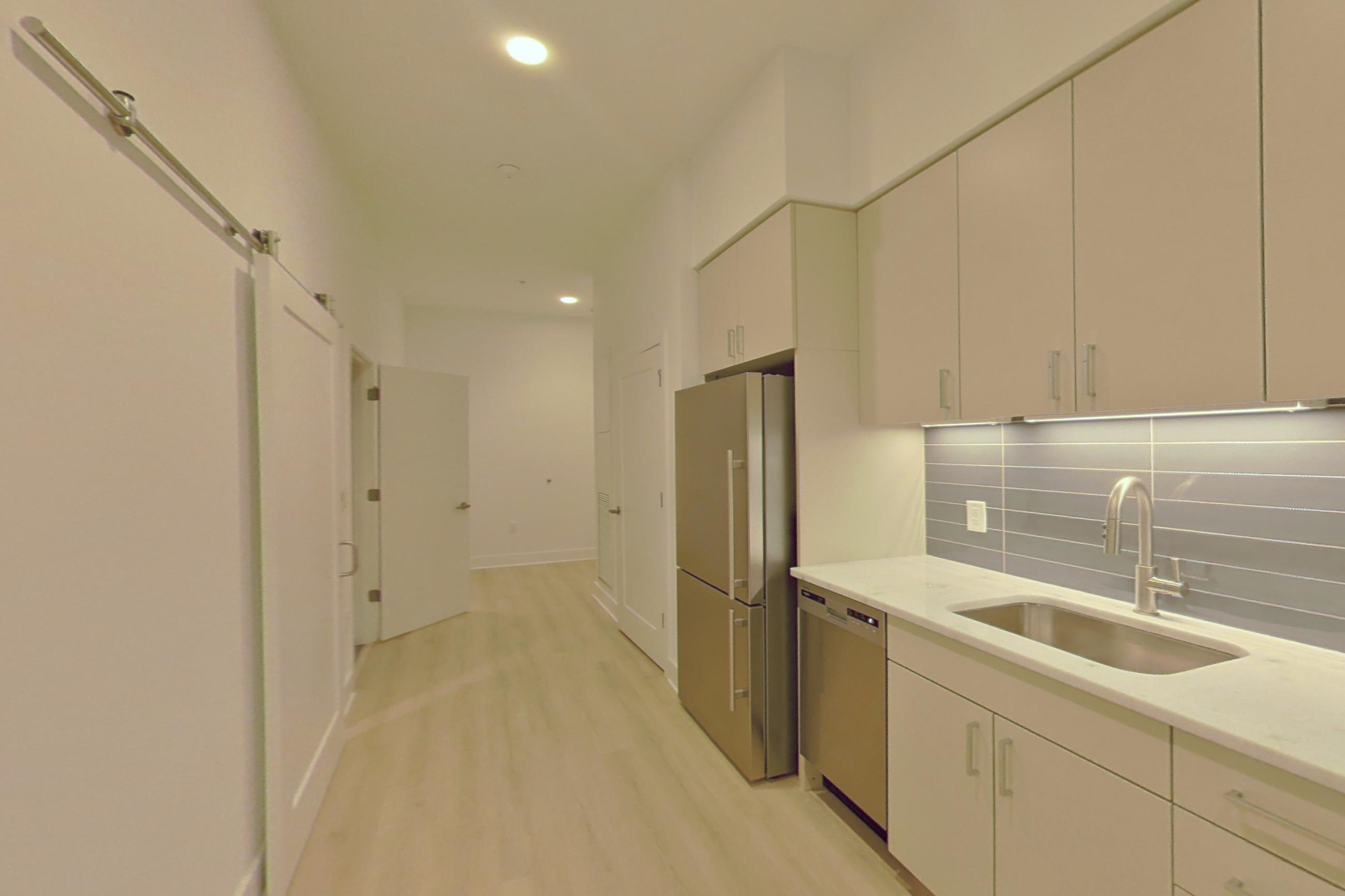 Kitchen with light wood-finish flooring, Apartment 116 at SoNYa