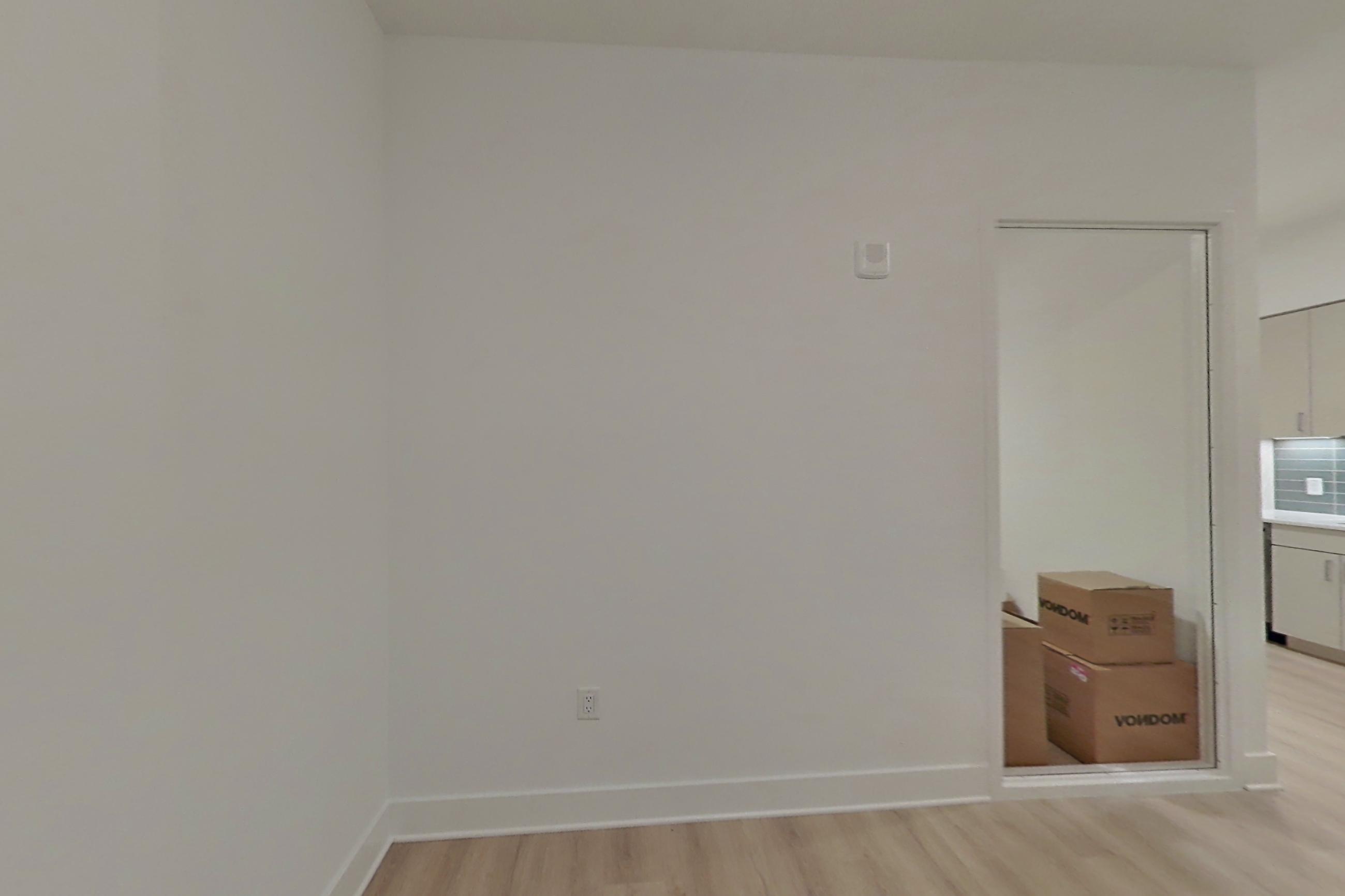 Living space with electric range and light wood-finish flooring, Apartment 116 at SoNYa