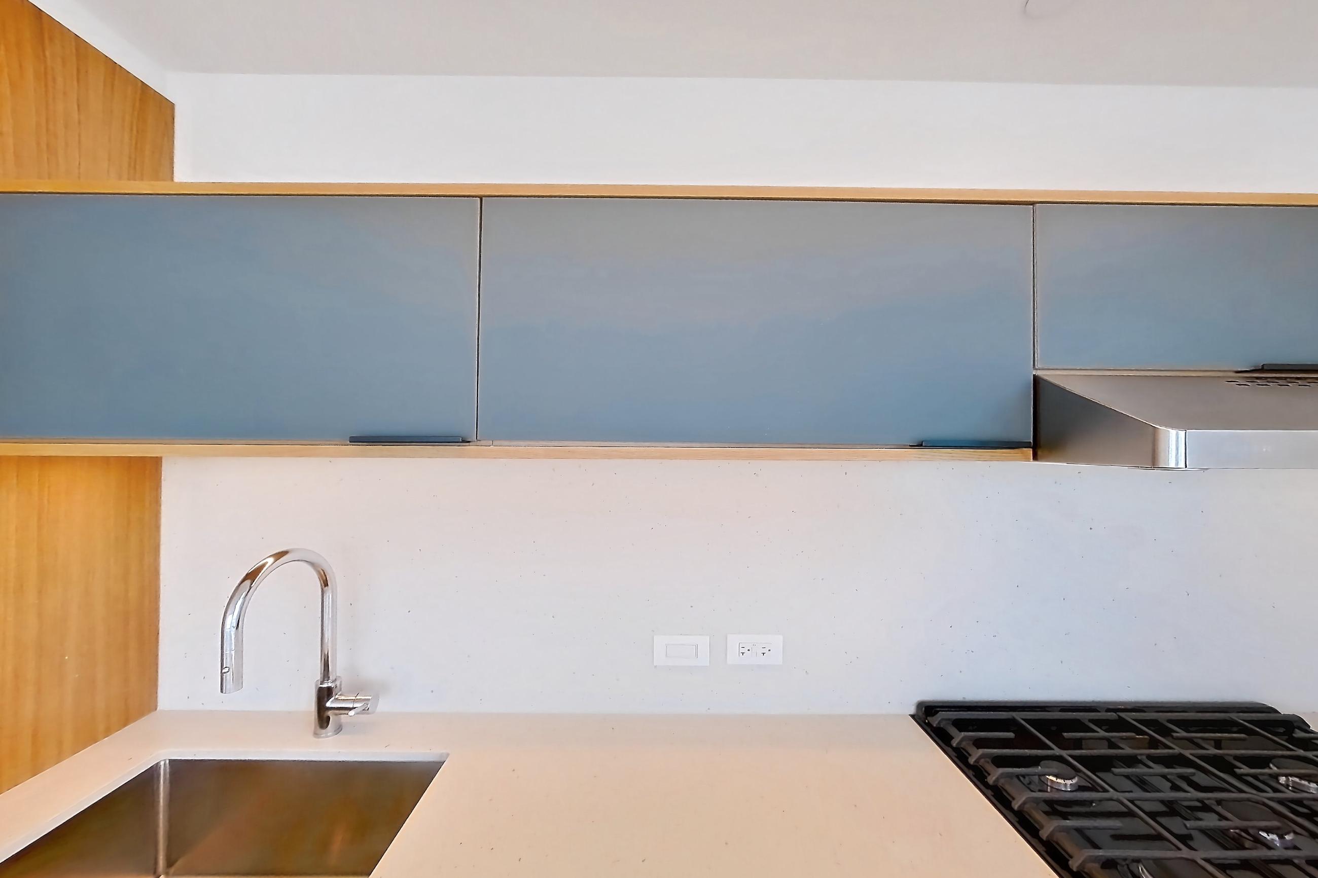 Kitchen with city view, gas range, light stone countertops, light wood-finish flooring, oven/range, and stainless steel appliances, Apartment 0-PHF at The Bellslip