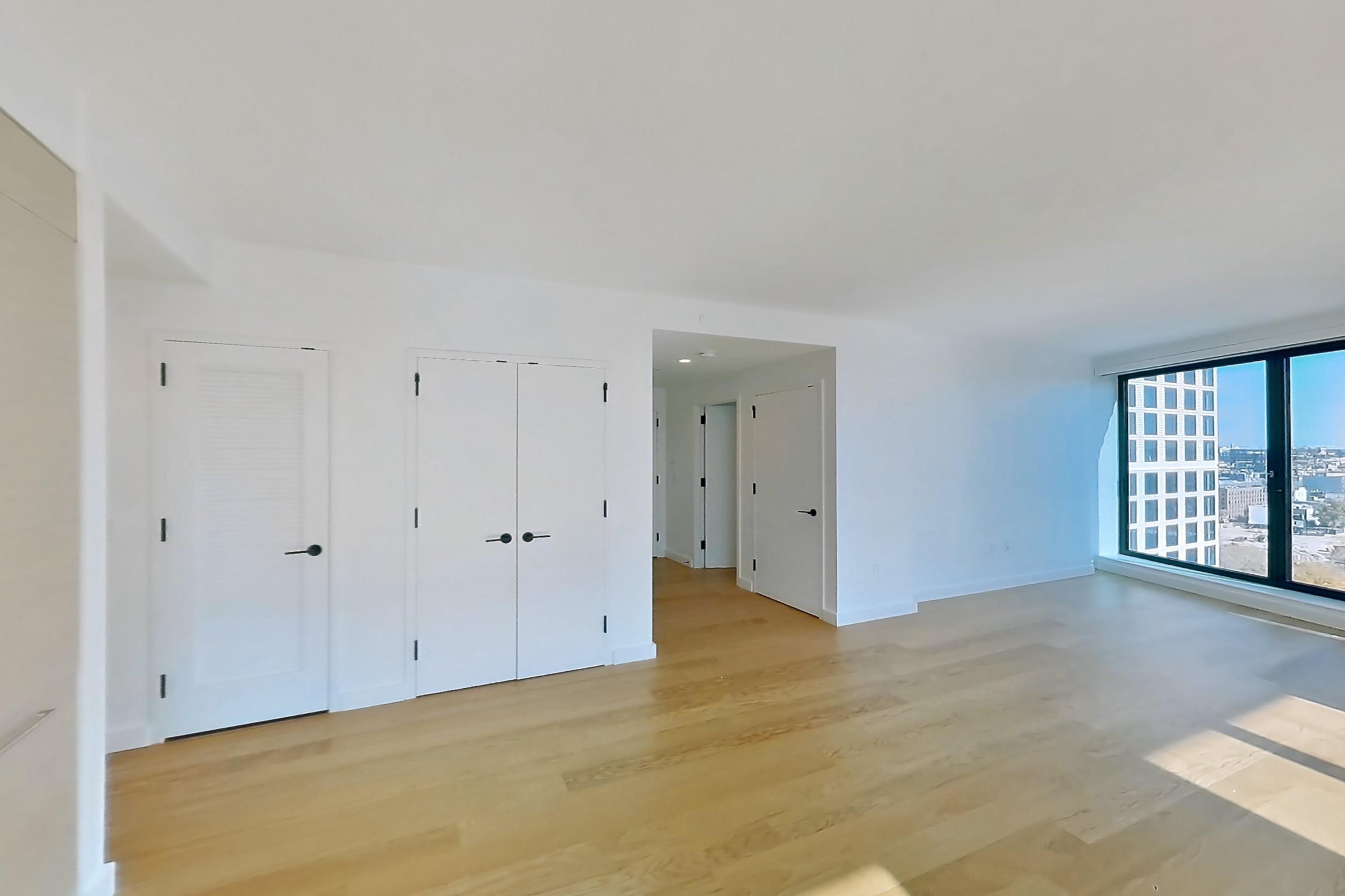 Kitchen with gas range, light wood-finish flooring, oven/range, and stainless steel appliances, Apartment 1-1509 at Eagle + West
