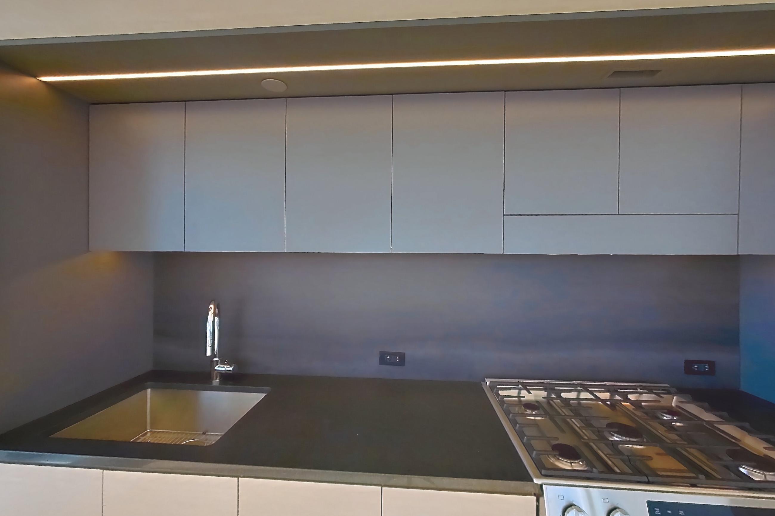 Kitchen with gas range, light wood-finish flooring, oven/range, and stainless steel appliances, Apartment 1-1509 at Eagle + West