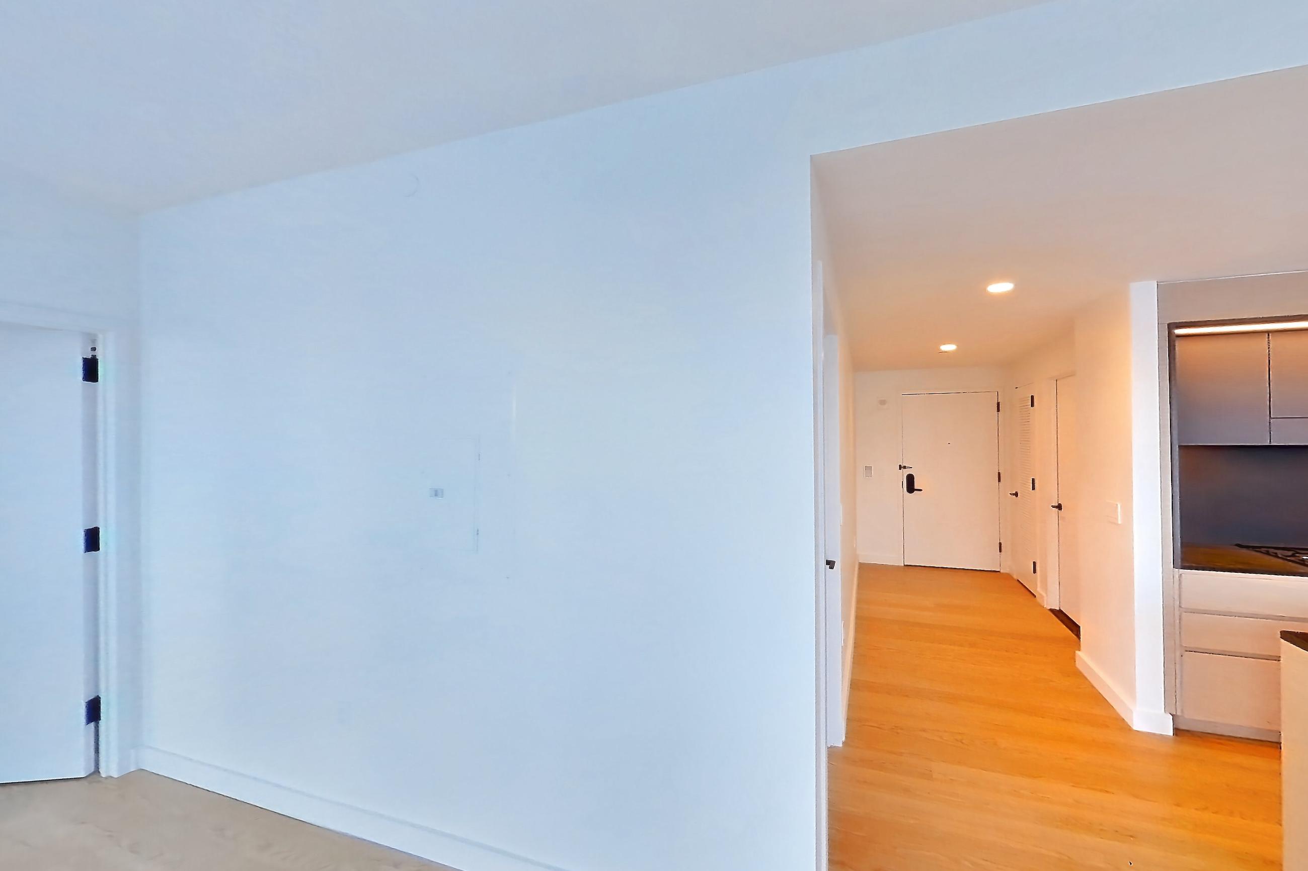 Living room with city view, light wood-finish flooring, and water view, Apartment 506 at Eagle + West