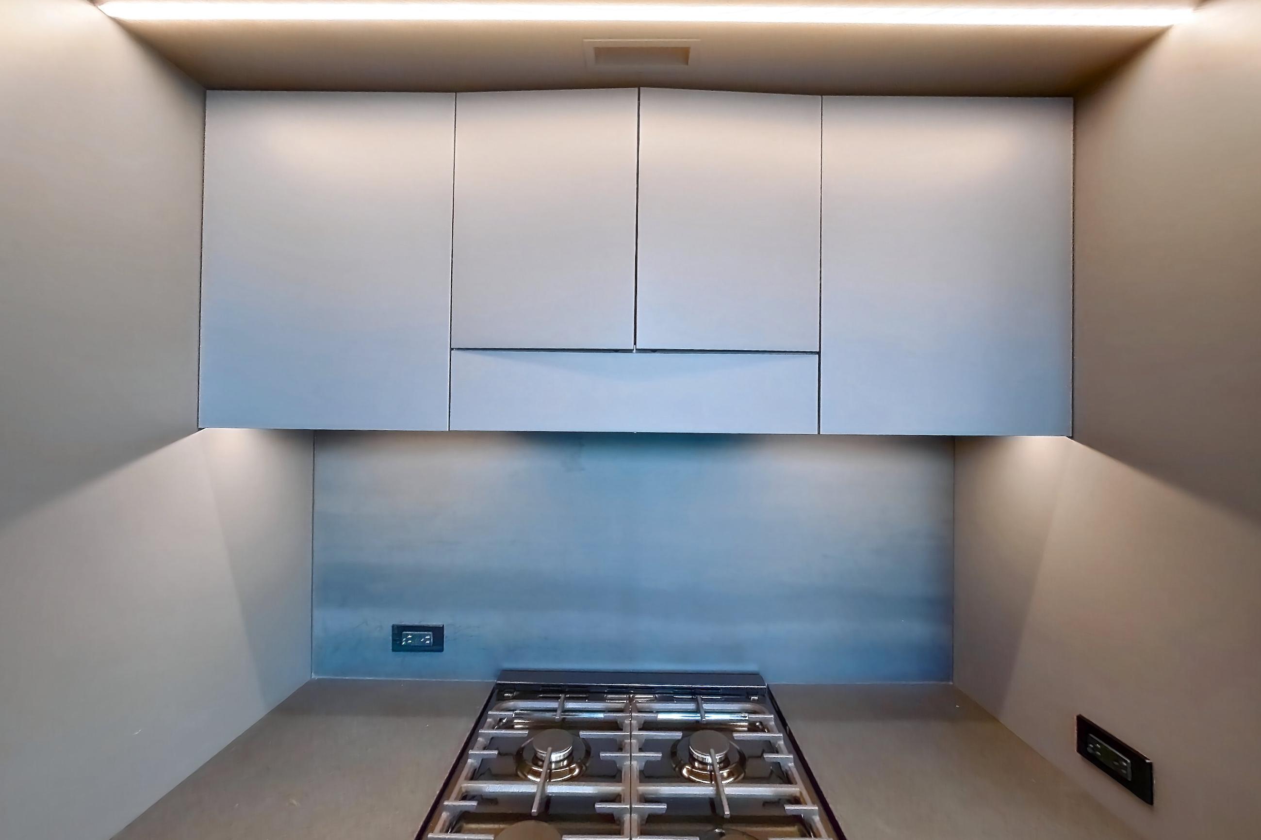 Kitchen with gas range, light wood-finish flooring, oven/range, and stainless steel appliances, Apartment 1-0110 at Eagle + West