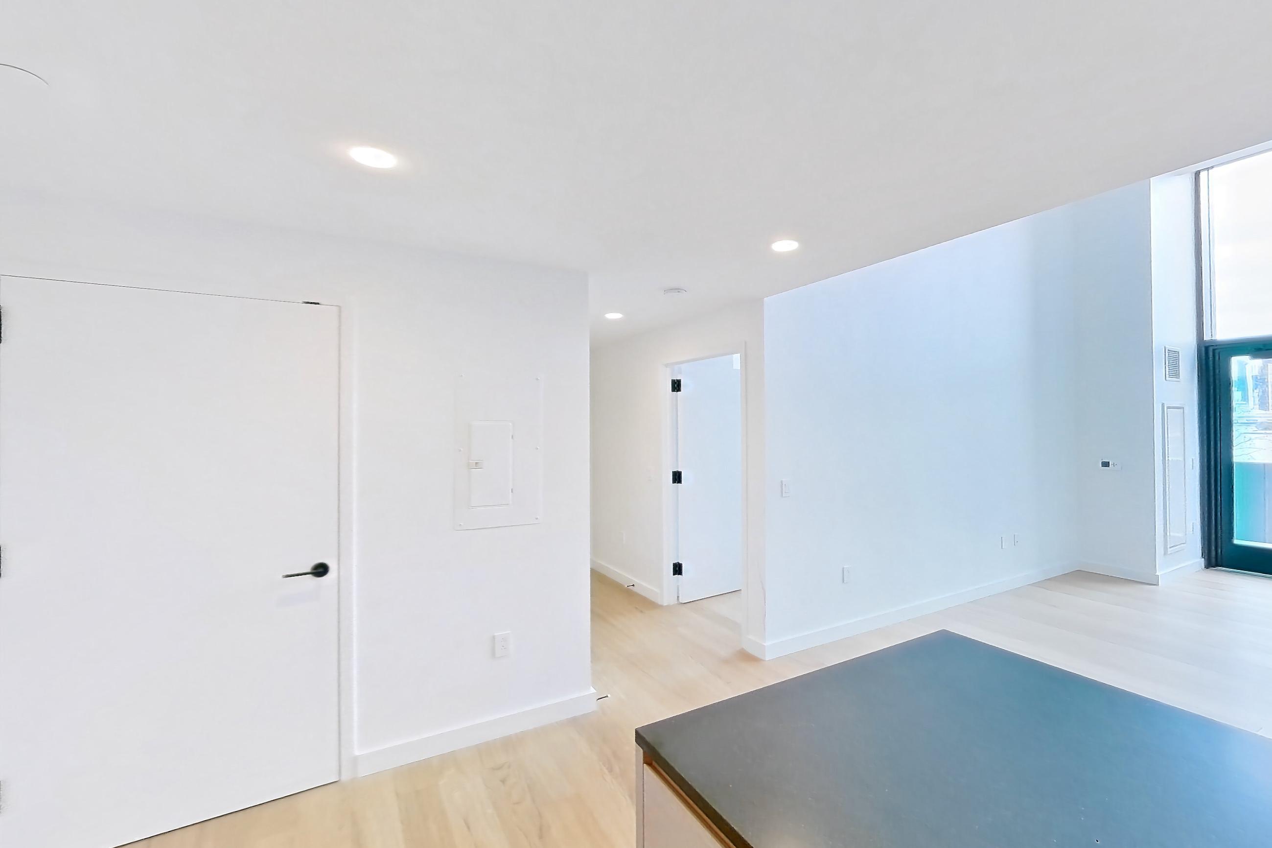 Kitchen with gas range, light wood-finish flooring, oven/range, and stainless steel appliances, Apartment 1-0110 at Eagle + West