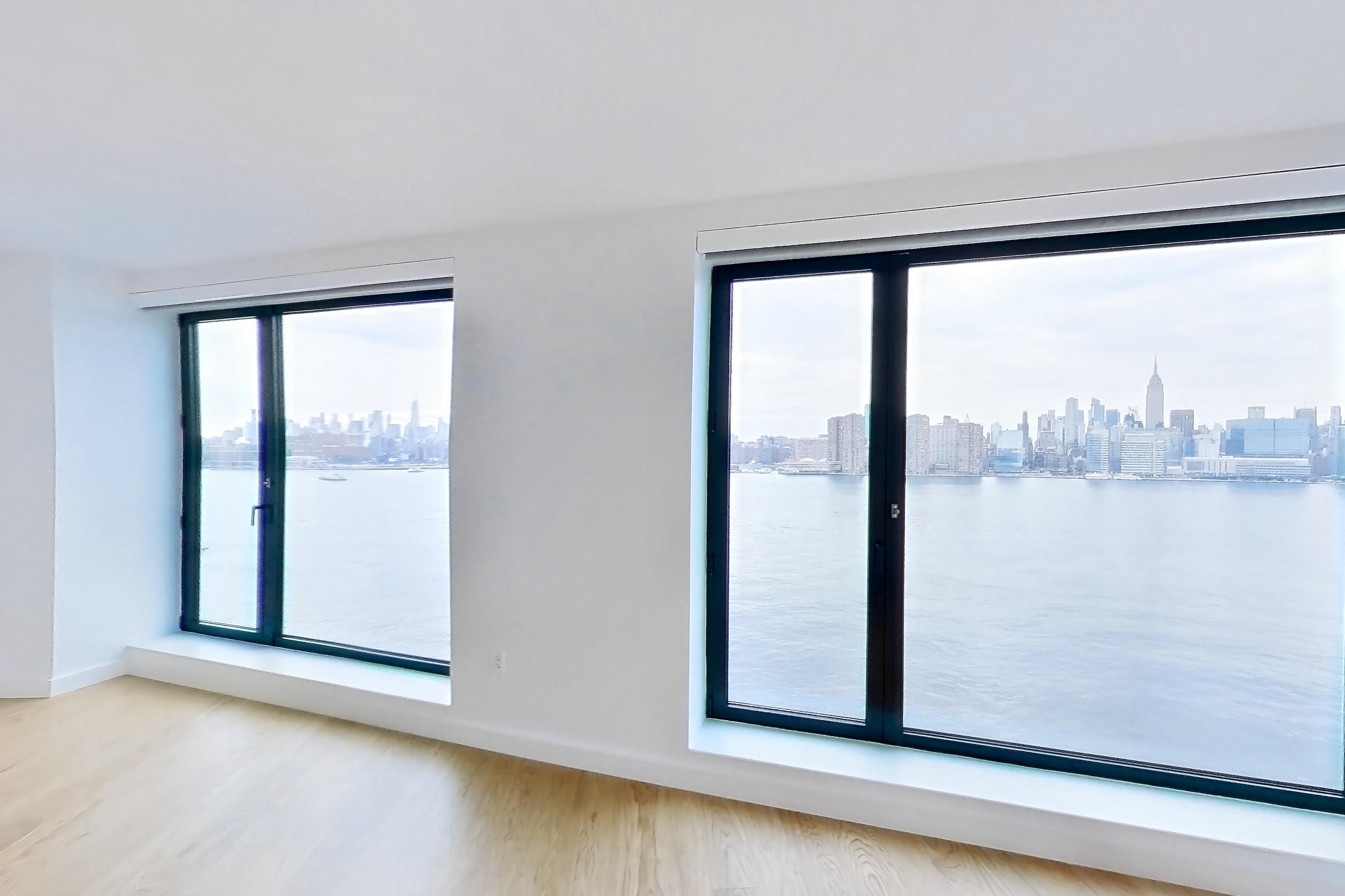 Living room with city view, light wood-finish flooring, and water view, Apartment 1-1604 at Eagle + West