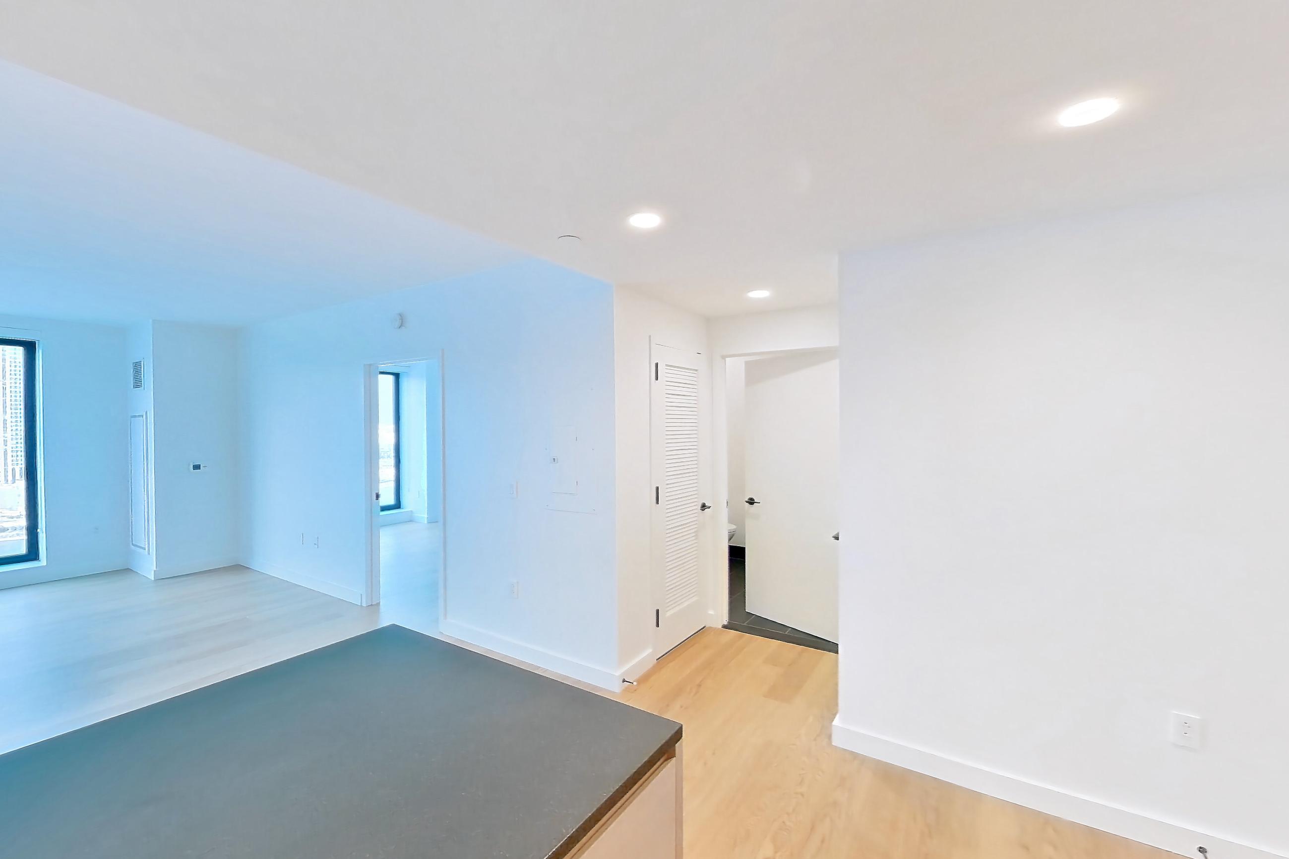 Kitchen with gas range, light wood-finish flooring, oven/range, and stainless steel appliances, Apartment 1-1905 at Eagle + West