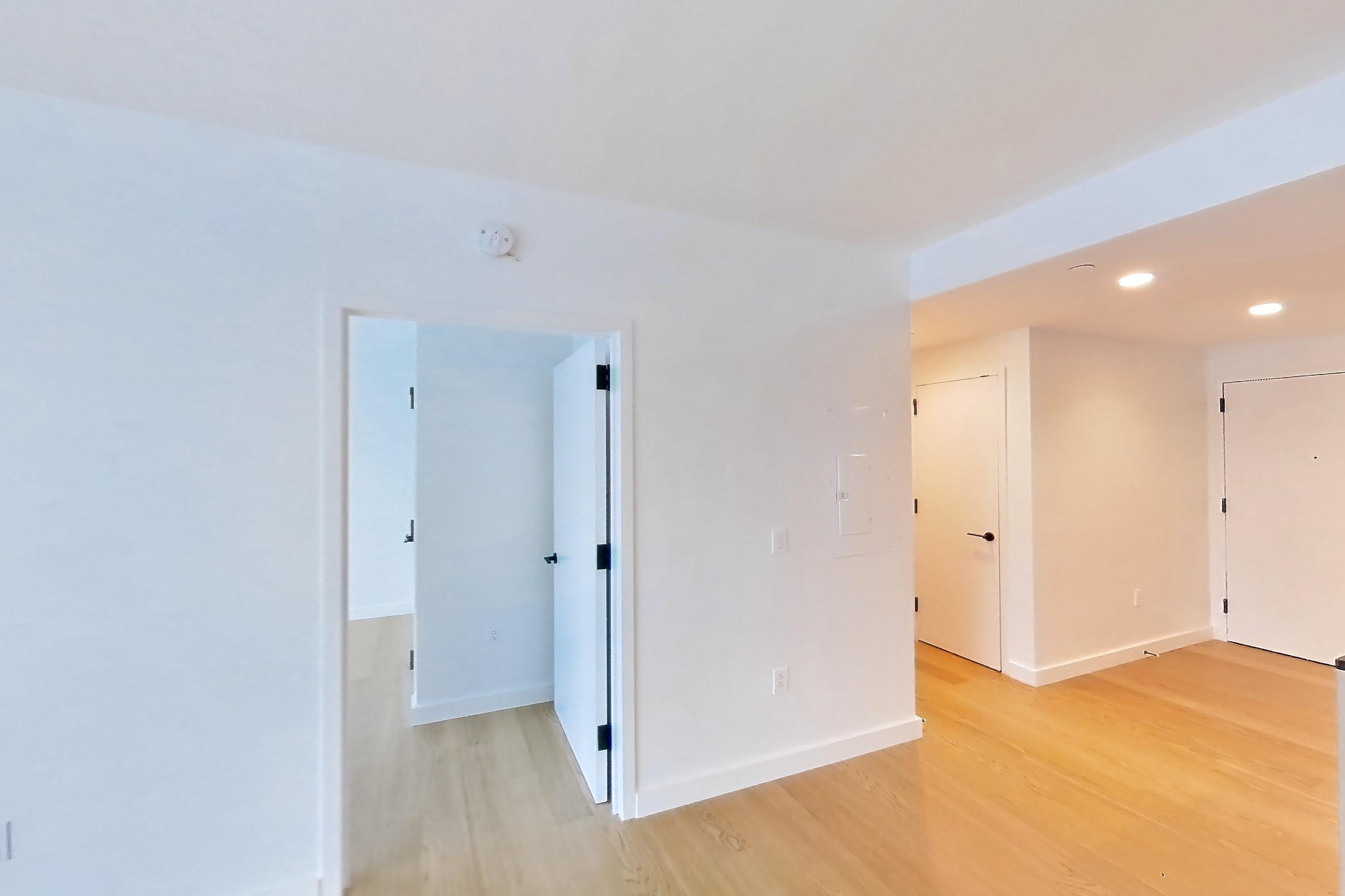 Living room with light wood-finish flooring, Apartment 1-1905 at Eagle + West