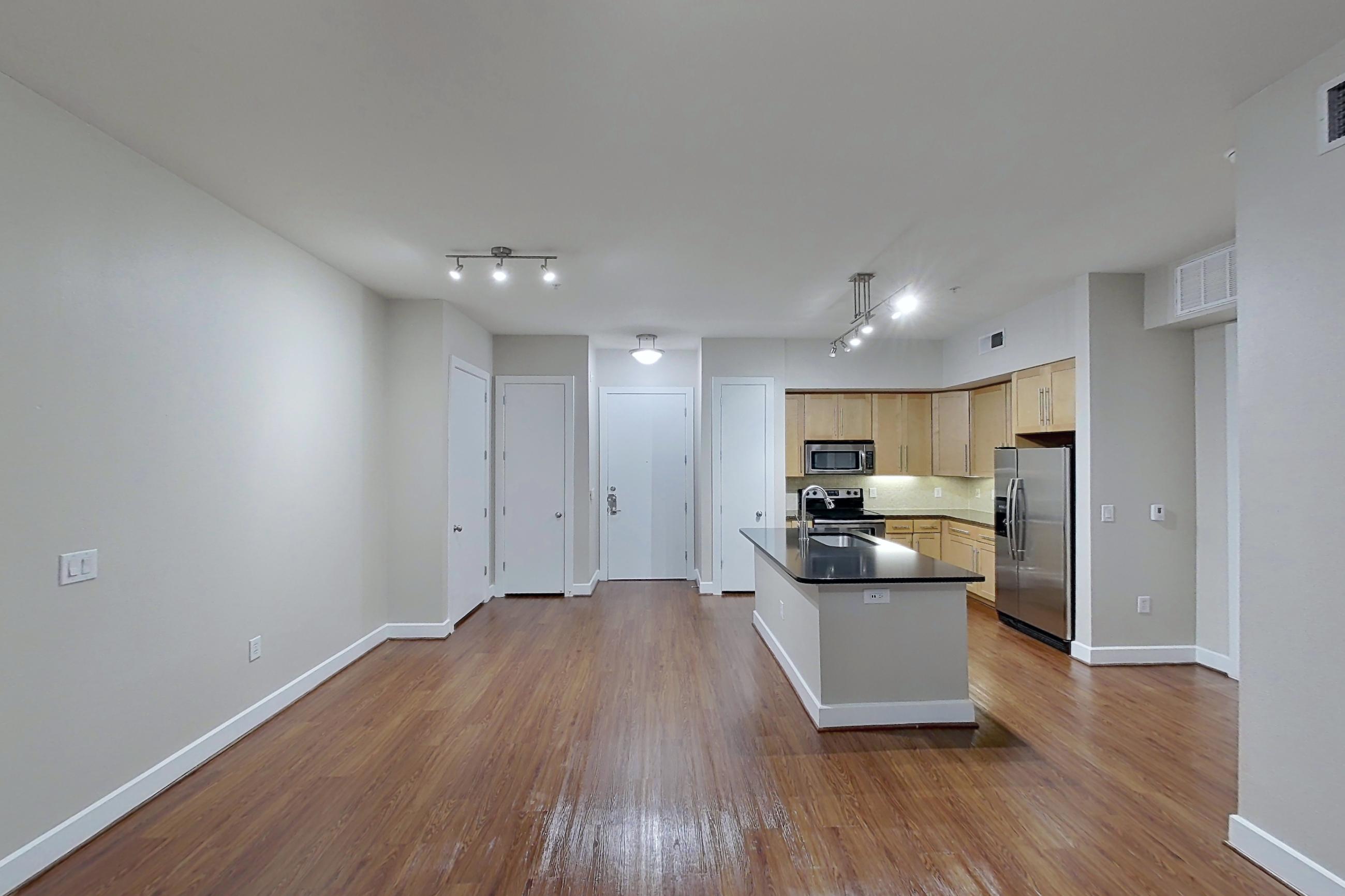 Living room with dark countertops, dark wood-finish flooring, electric range, kitchen island, oven/range, refrigerator, stainless steel appliances, and water & ice dispenser, Apartment 160 at Domain at CityCentre